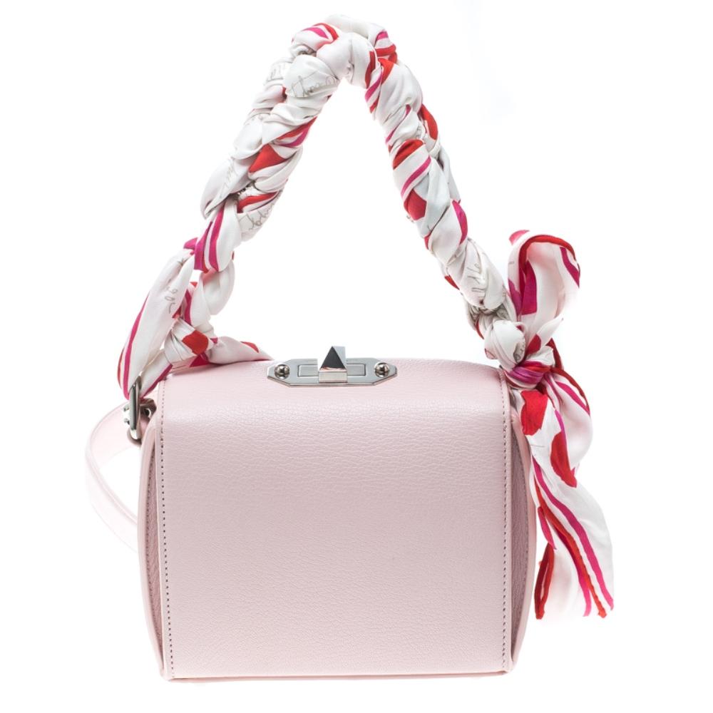 From the house of Alexander McQueen comes this gorgeous box shoulder bag that will perfectly complement all your outfits. It has been luxuriously crafted from blushed pink leather and styled into a box shape with a silver-tone turn lock on top and a