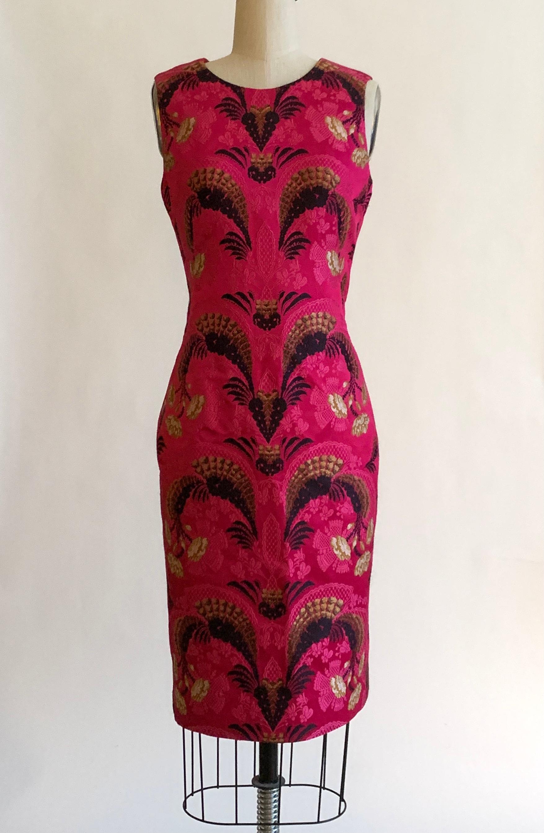 Alexander Mcqueen deep pink dress with a stunning gold and black Oriental inspired floral weave throughout, circa 2011. Fitted pencil style, sleeveless. Back zip and hook and eye with short slit at back. 

69% polyester, 17% silk, 14% viscose.