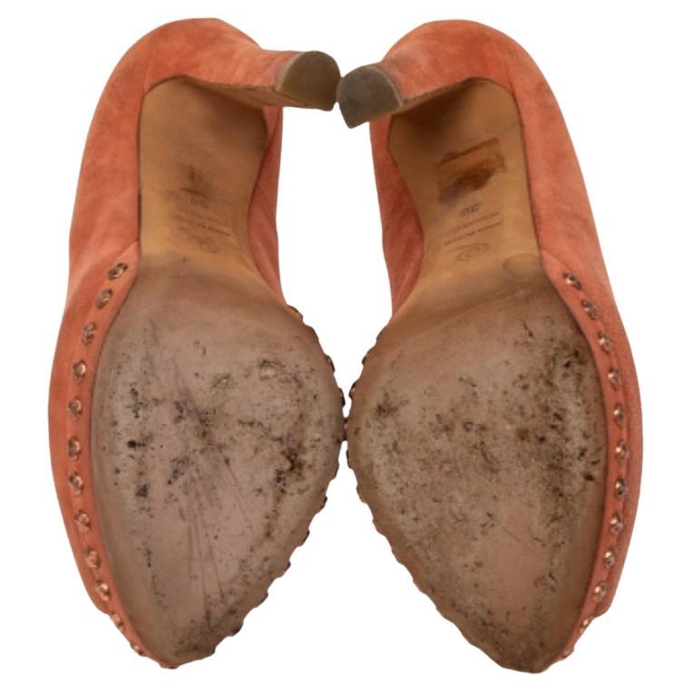 If you are someone who has a love for things that are edgy and unique, then Alexander McQueen's designs are perfect for you. These McQueen pumps are anything but dull. Luxuriously crafted from suede, they feature gold-tone skull motifs over the peep