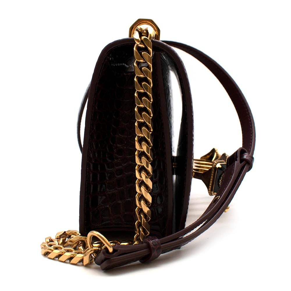 Alexander McQueen Burgundy Knuckle Crocodile Cross Body Bag

- From AW18 Collection
- Crafted from crocodile-effect leather
- Gold-tone metal knuckle clasp
- Faux-pearl and crystal-embellished creatures
- Leather and Gold-tone cross-body chain
-
