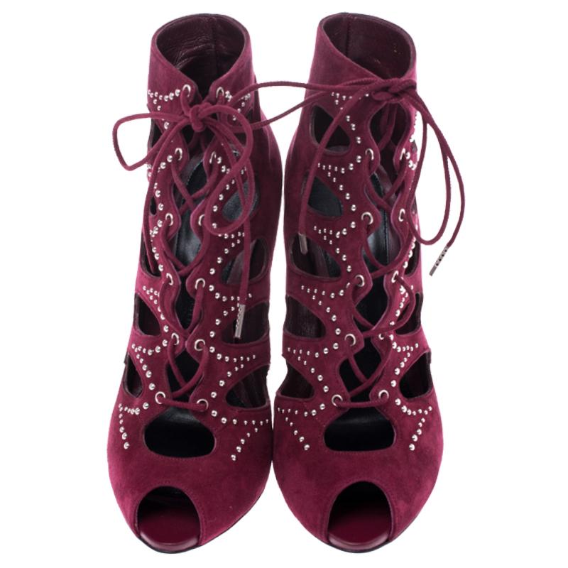 Alexander McQueen exudes their high style and unique fashion taste with these booties. They are brimming with exquisite details like the silver stud details on the burgundy suede exterior, the laces, and towering stiletto heels. Grab this pair today