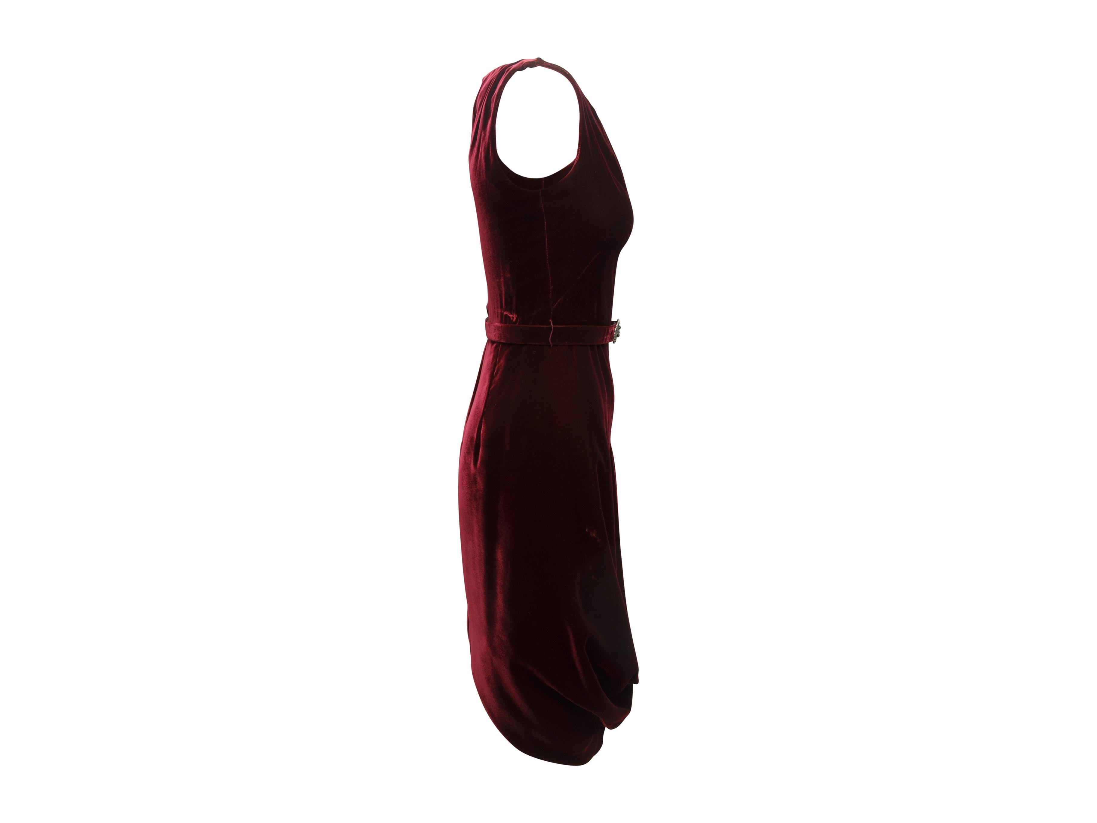 Product details: Burgundy sleeveless velvet dress by Alexander McQueen. Round neckline. Draping at skirt. Belt accent at waist. Zip closure at back. Designer size 40. 32