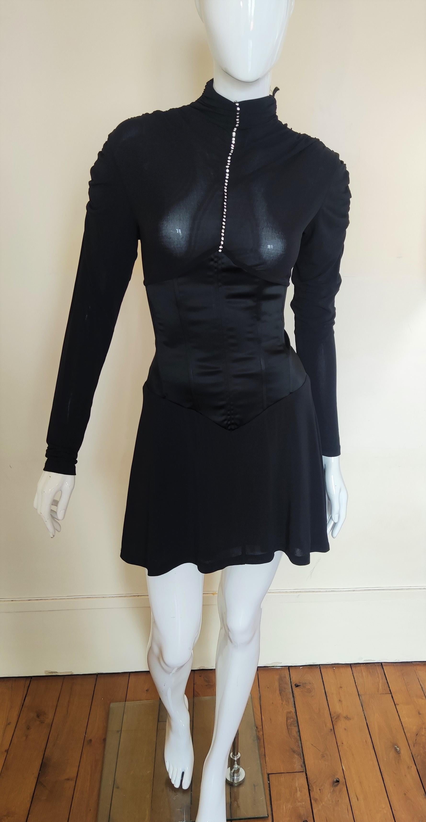 Alexander McQueen Swaorwski dress.
With 53 Swarovski stones. 
Extra high turtleneck.
Corset at the waist. 
Semi transparent at the top and the sleeves. 
New with Tag!

SIZE
Medium. Marked size: IT44. 
Stretchy fabric!
Length: 80 cm / 31.5 inch
Bust: