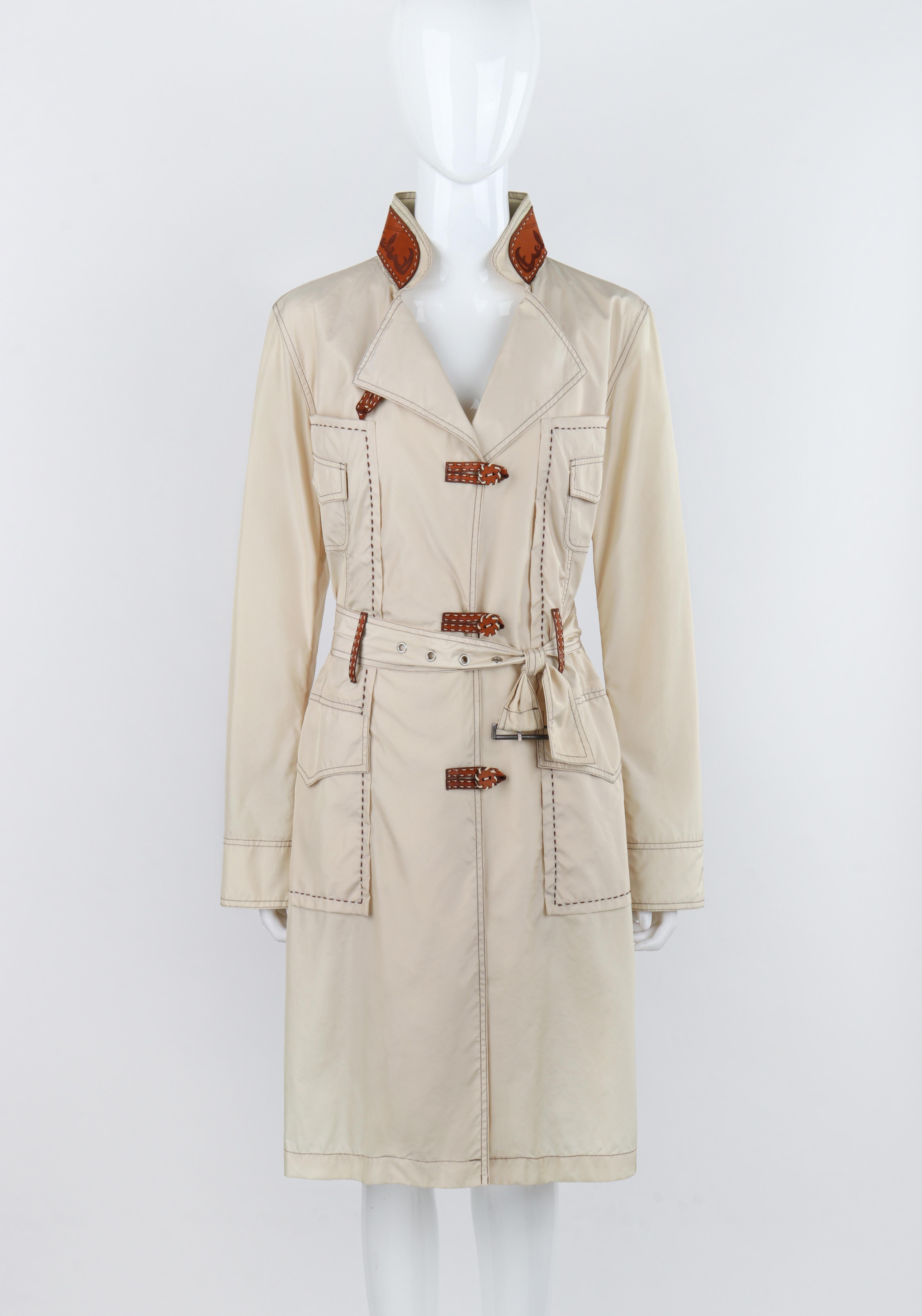 ALEXANDER McQUEEN c.1996 Vtg Beige Leather Accent Western Trench Coat Overcoat 

Brand / Manufacturer: Alexander McQueen
Circa: 1996
Designer: Alexander McQueen
Style: Trench Coat
Color(s): Beige, Brown
Lined: No
Marked Fabric: 75% Nylon, 25%