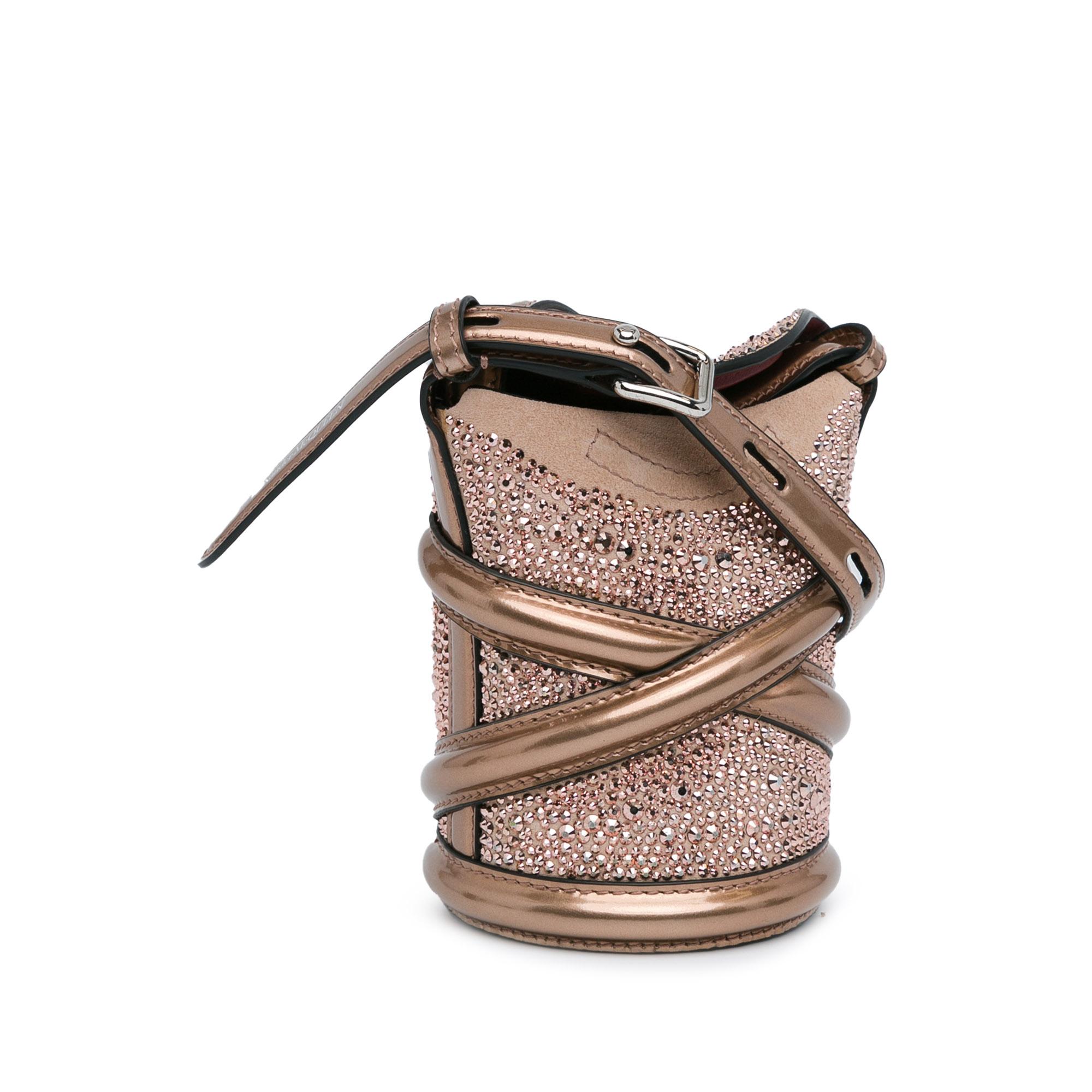 This bucket bag features a leather body with crystal embellishments, an adjustable flat leather shoulder strap, fold-over top flaps with magnetic snap closure, and an interior slip pocket.
Very good condition.
Small signs of wear, not very visible.