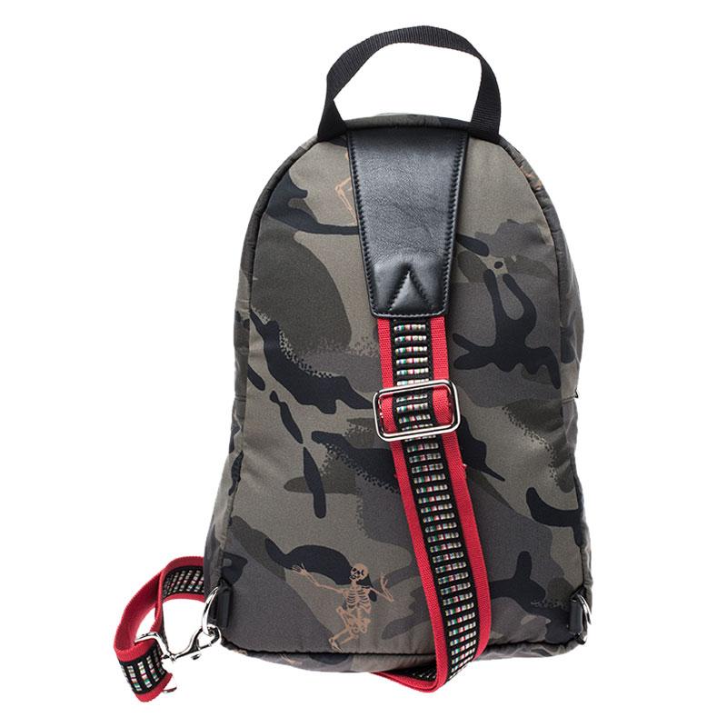 This Alexander McQueen bag will come in handy for daily use or as a style statement. It is crafted from camo nylon and designed with dancing skeletons and a spacious interior secured by zippers. A single crossbody strap and a small top handle make