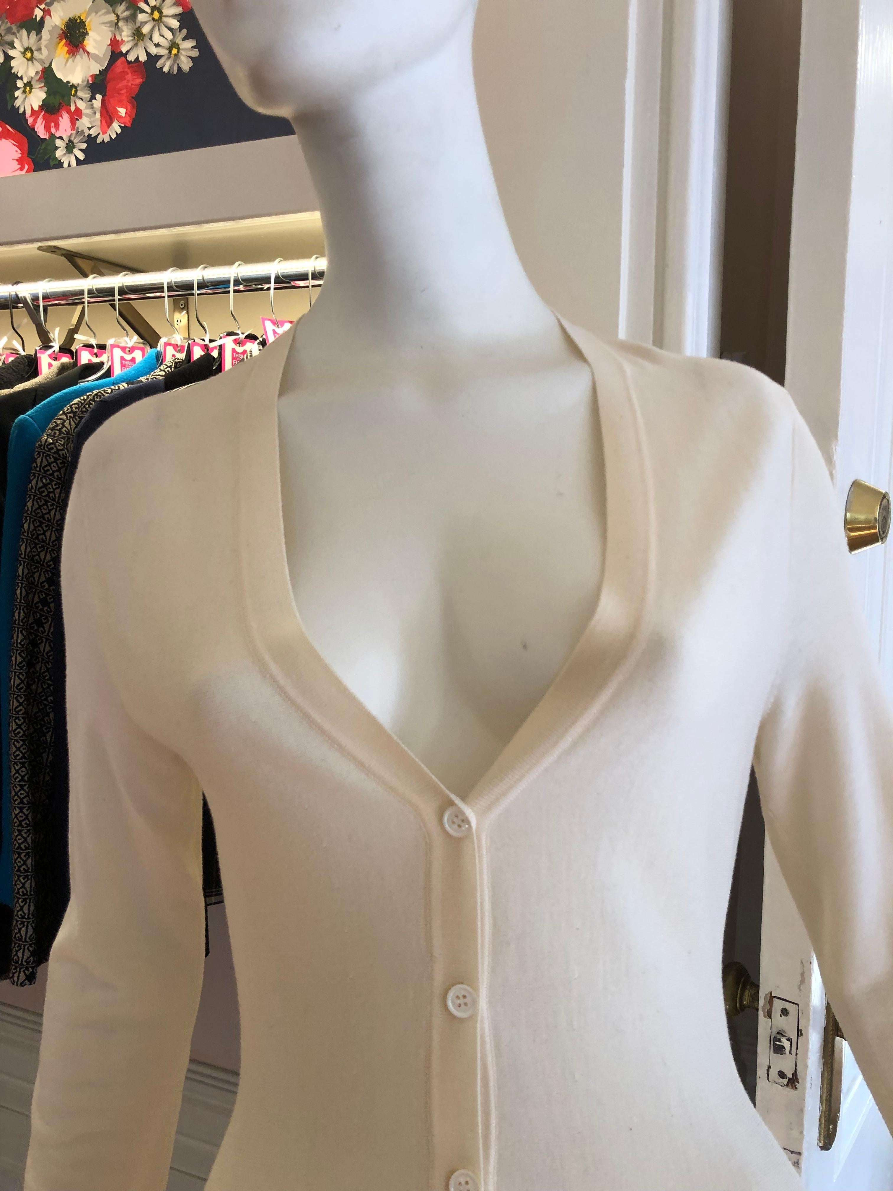 Wonderful and light weight Alexander McQueen by Sarah Burton peplum cardigan with a V-neck and button front fastening. Very flattering style.
This cardigan is in excellent condition with a very tiny hole at the back neckline (see picture).
There is