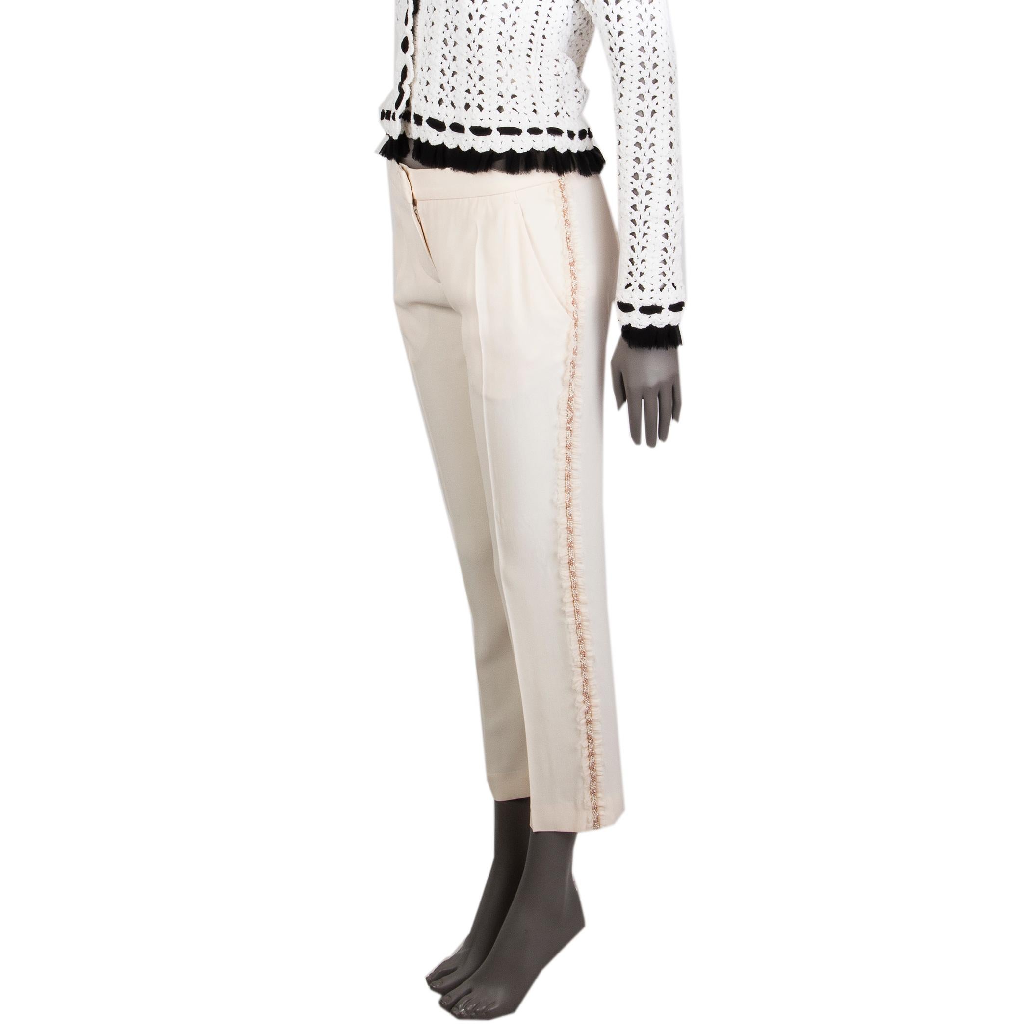 100% authentic Alexander McQueen tapered pants light cream acetate (45%), viscose (45%), and silk (10%). With beaded braid and fray trimmings down the side seams, two fdiagonal pockets on the front, and one welt pocket on the back. Close with