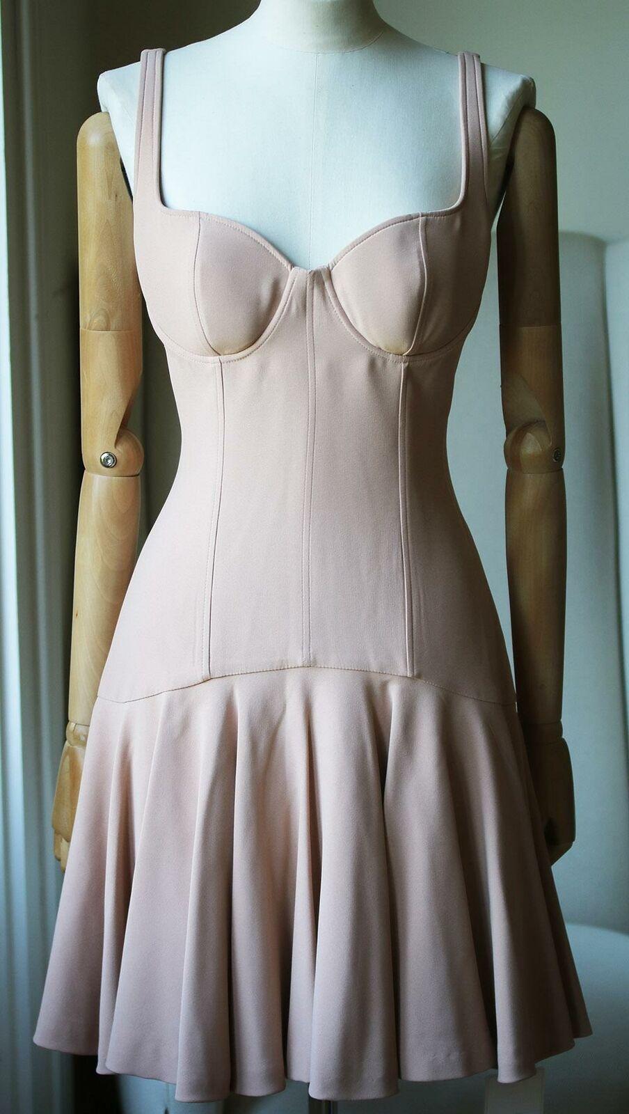 Nude crepe bustier dress from alexander mcqueen. Defined underwired cups. Structured bust with boning. Concealed zip down back. Sleeveless. Thin straps. Fluted flared skirt. Fully lined. Colour: nude. 50% acetate, 50% rayon.

Size: IT 42 (UK 10, US