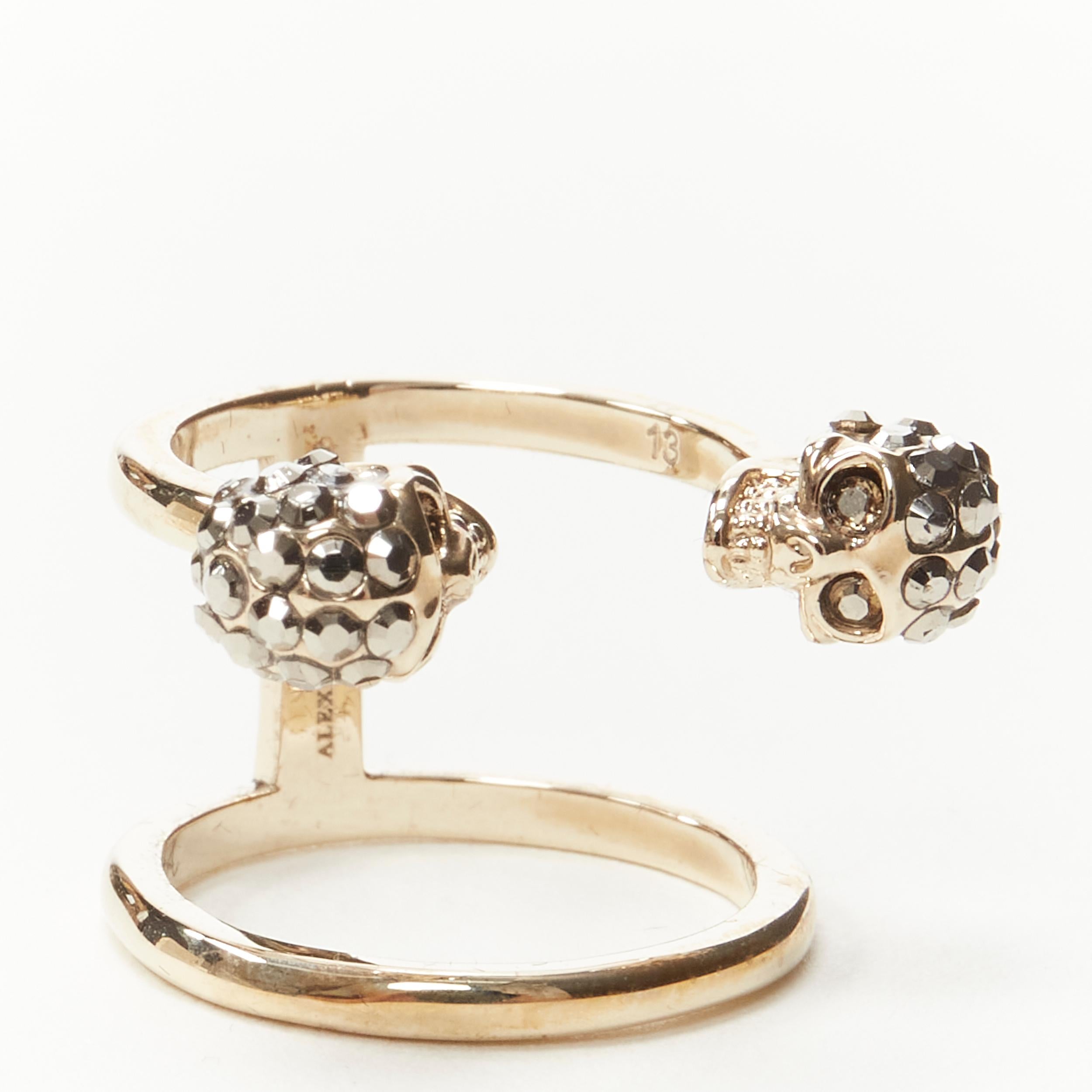 ALEXANDER MCQUEEN crystal encrusted double skull gold tone double ring 6.5 
Reference: KEDG/A00021 
Brand: Alexander McQueen 
Material: Metal 
Color: Gold 
Pattern: Solid 
Made in: Italy 

CONDITION: 
Condition: Excellent, this item was pre-owned