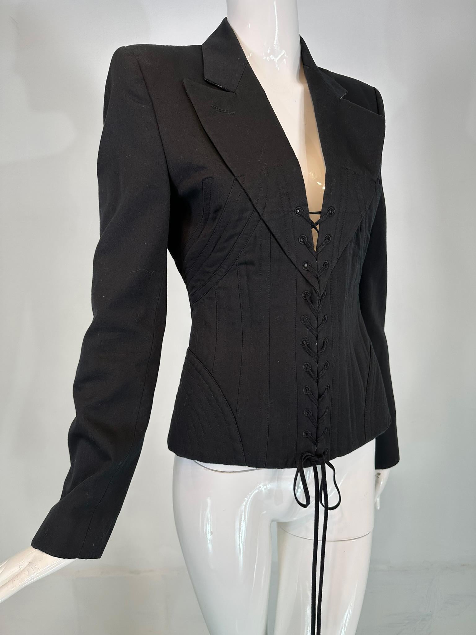 Alexander McQueen, Spring 2002, ' Dance of the Twisted Bull' Collection, look 21. Black wool/cotton blend corseted jacket. Long sleeve jacket with notched lapels, the collar is backed with wool flannel. The jacket closes at the front with black cord