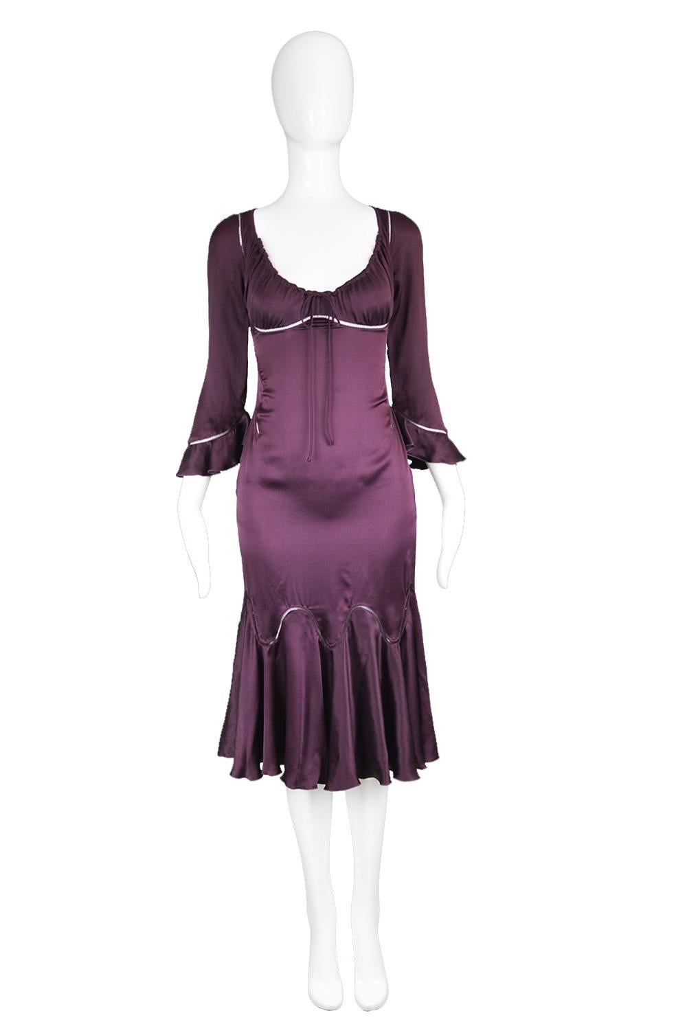 A stunning vintage party dress by legendary British fashion designer, Alexander McQueen for his autumn winter 2002 'Supercalifragilisticexpialidocious' collection. Made in Italy in a dark purple / aubergine colored silk satin / charmeuse with open
