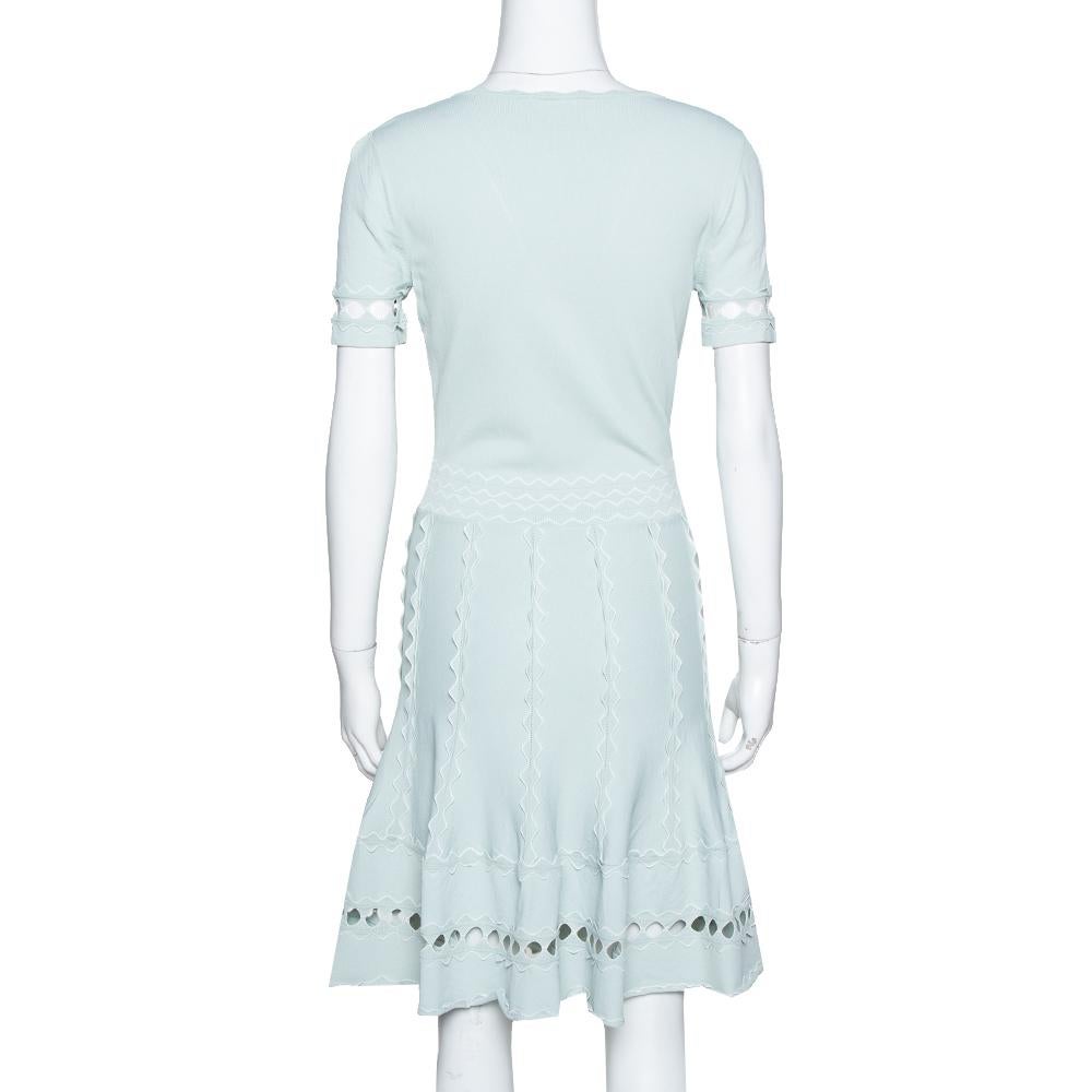 This egg blue dress is from the house of Alexander McQueen. This dress wins with its feminine design of plunging neckline, flute sleeves and a fitted silhouette. It is sleeveless and has a short hem.

