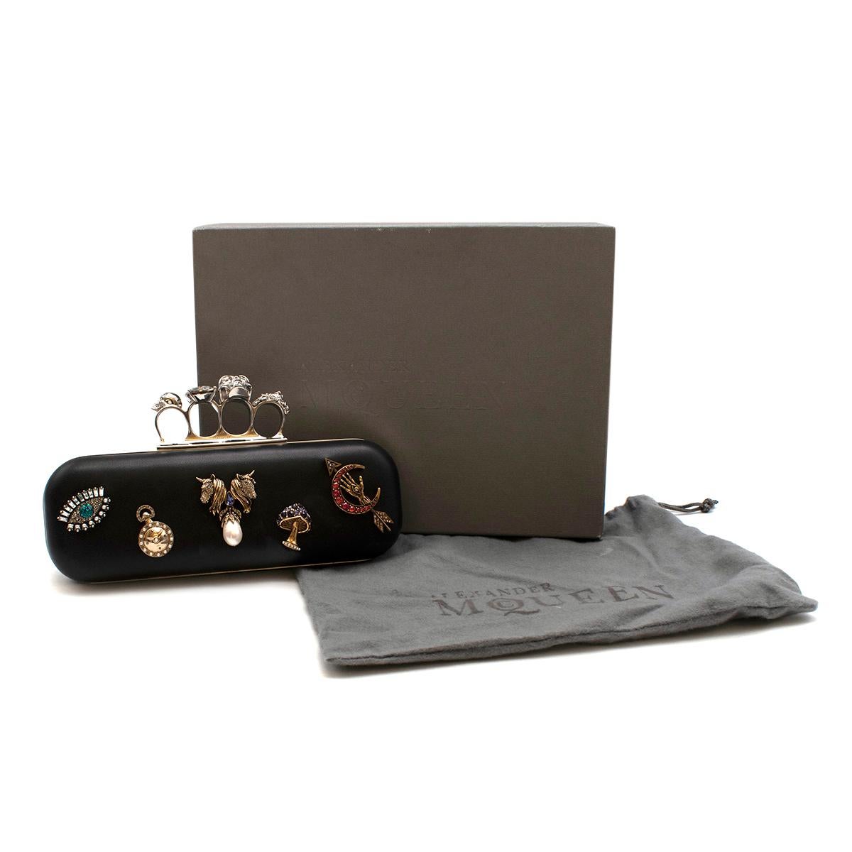 Alexander McQueen embellished black leather four-ring clutch bag

- Silver push-clasp fastening
- Soft Black Calfskin Body with calfskin lining
- Designed with silver and gold-tone hardware
- Embellished with faux pearl and crystal classic McQueen