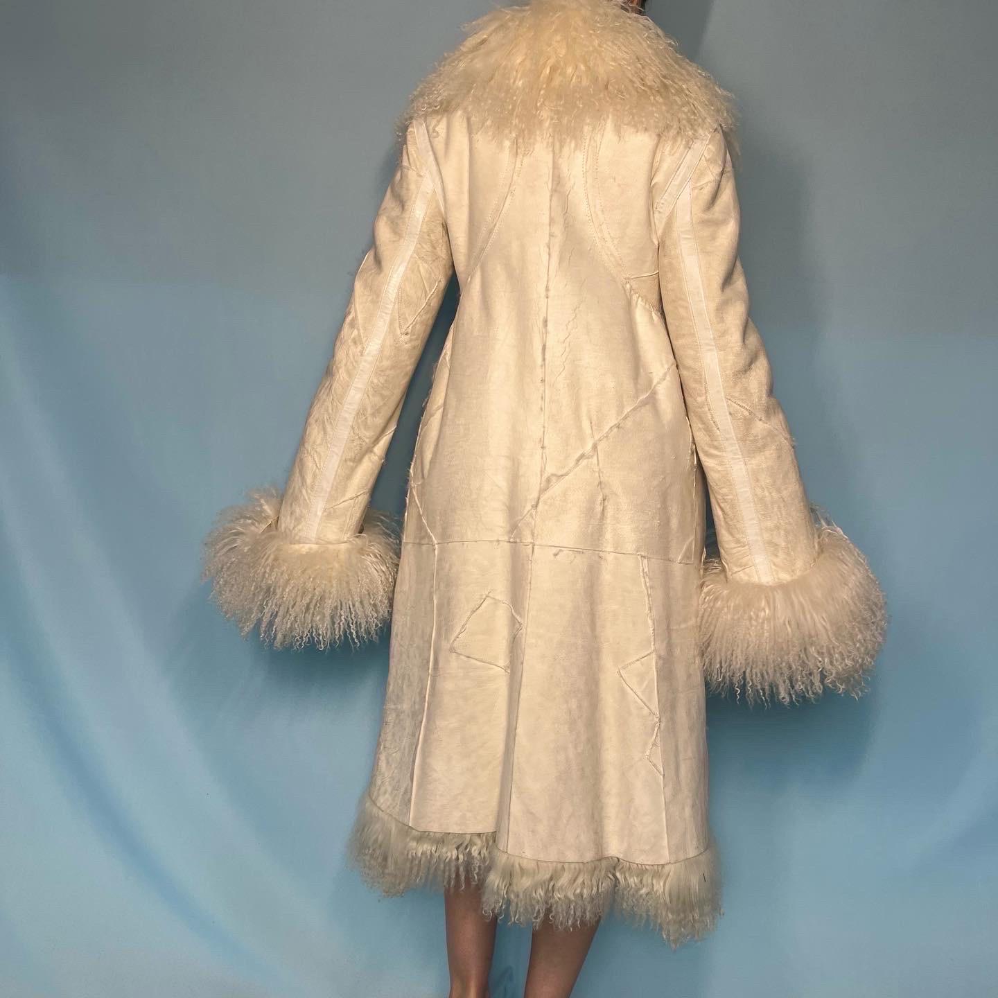Alexander McQueen  

Fall 2003 “Scanners” Runway show piece - this jacket is the exact one that was worn by the model on the runway 

White suede patchwork detail jacket 

Mongolian lamb fur lined 

Large fur collar

Zip up 

Cuffs can be folded up