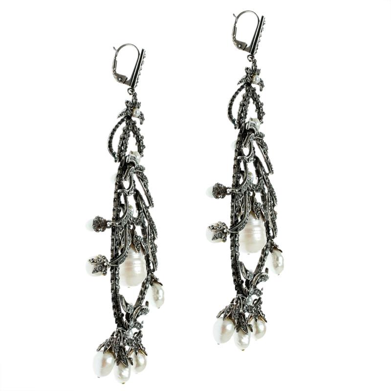 Designed in an attractive silver-tone body, these earrings from Alexander McQueen are utterly gorgeous and feminine. They are styled in a drop silhouette. Crystals and faux pearls are arranged in a lovely pattern for dazzling display. Styled as