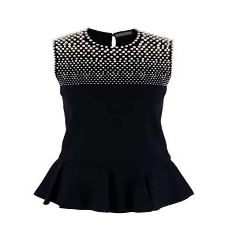Alexander McQueen Faux-Pearl Embellished Black Knitted Top

- Form-fitting viscose knit sleeveless top with peplum hem and faux-pearl adornment across the chest and shoulders
- Unlined 

Materials 
83% Viscose 
17% Polyester 

Made In Italy 
Dry