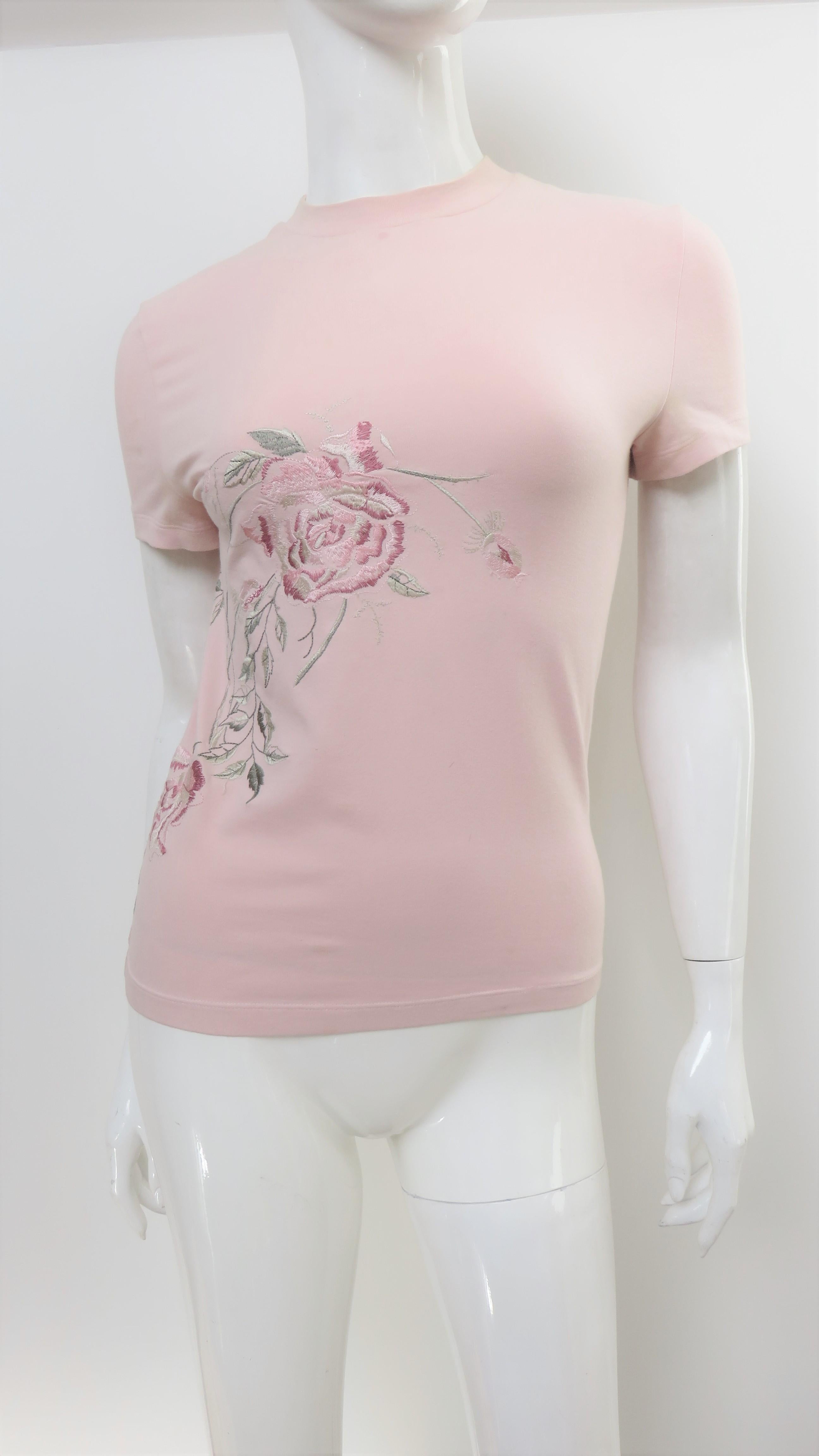 A beautiful pink cotton short sleeve t shirt from an early collection of Alexander McQueen.  It has embroidered roses in shades of pink with green leaves along one side.  
Fits sizes Extra Small, Small. Marked Italian size 42.

Bust  33-35