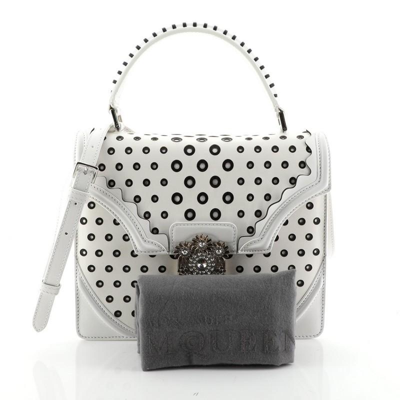 This Alexander McQueen Flower Satchel Perforated Leather Medium, crafted in white leather, features a leather top handle, perforated detailing and silver-tone hardware. Its push-lock closure opens to a black suede interior with a center zip