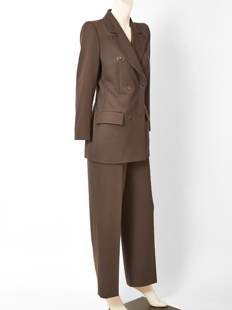 Alexander McQueen for Givenchy Couture, chocolate brown, double breasted, wool, trouser suit, having wide lapels, a semi fitted jacket and an exaggerated shoulder silhouette. Jacket has flap pockets at the hip. Trousers have a fly front. 