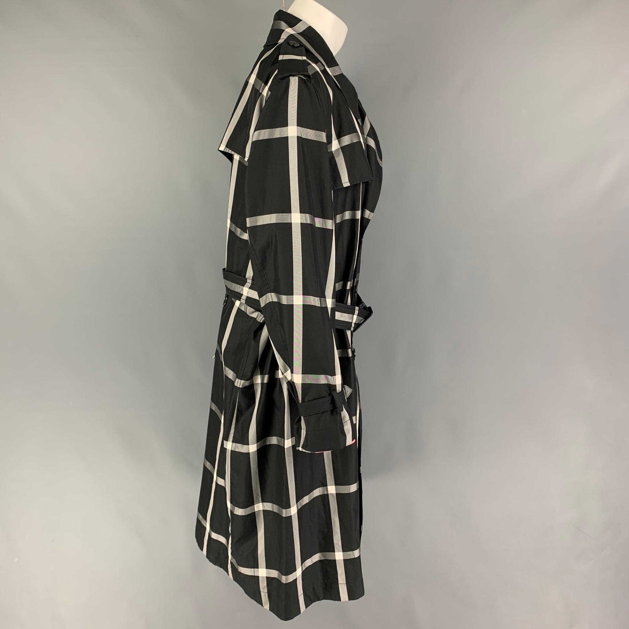ALEXANDER McQUEEN trenchcoat comes in a black & white windowpane polyester / silk featuring a belted style, storm flap, slit pockets, epaulettes, and a double breasted closure. Made in Italy. 

New With Tags. 
Marked: 48
Original Retail Price: