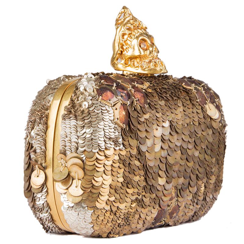 Alexander McQueen skull box clutch embellished with gold and silver-tone sequins. Opens with a crystal embellished gold-tone metal skull and is lined in dark brown leather. Has been worn and some sequins on top are missing. Overall condition is very