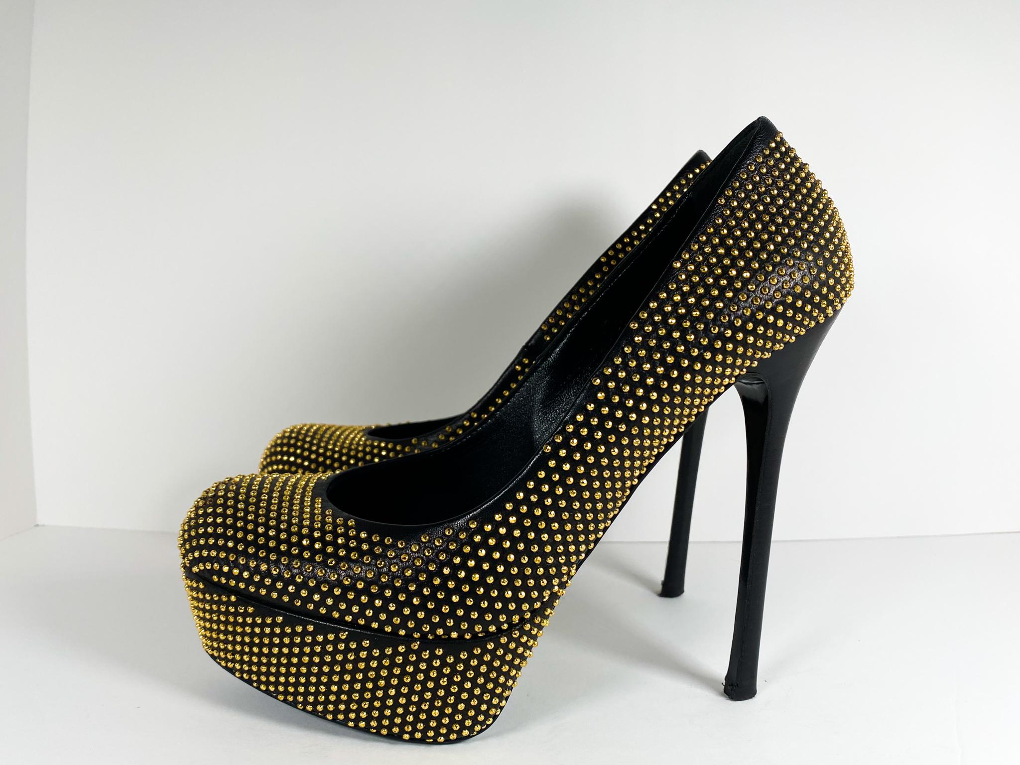 Alexander McQueen “Gold Stud Pumps”

Beautiful black leather heels decorated with gold-tone studs, featuring 6” heels on a 2” platform.

Condition: Good used condition.		
Exterior: Some wear on bottoms and heel tips, some discoloration / oxidation