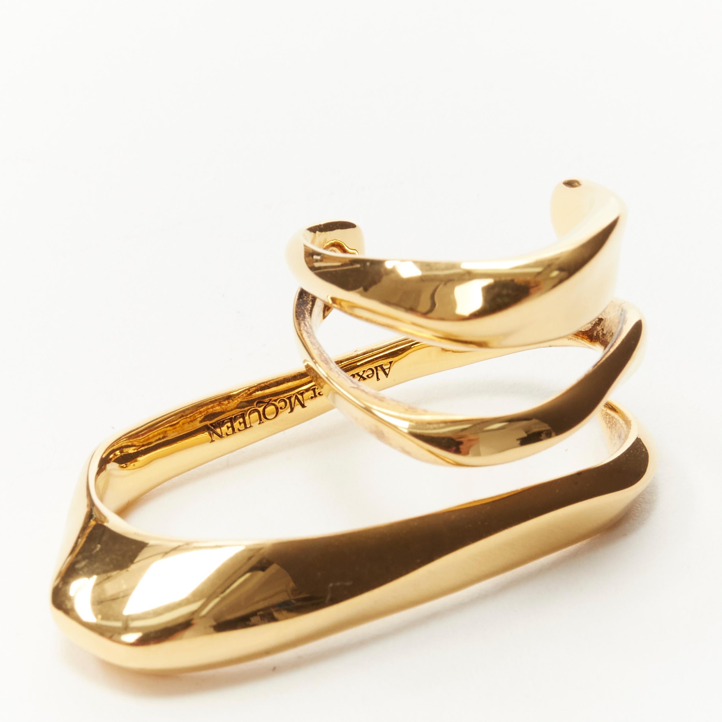 ALEXANDER MCQUEEN gold tone architectural double finger coil ring 
Reference: KEDG/A00023 
Brand: Alexander McQueen 
Designer: Sarah Burton 
Material: Metal 
Color: Gold 
Pattern: Solid 
Made in: Italy 

CONDITION: 
Condition: Excellent, this item