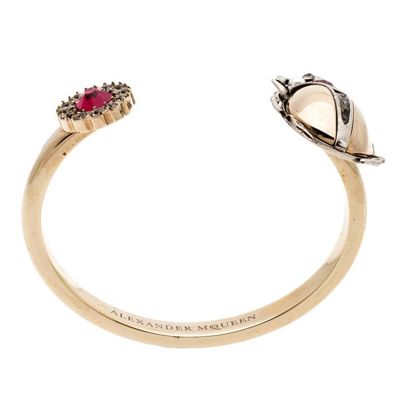 Quirky and very stylish, this bracelet from Alexander McQueen is here to enchant you and make you fall in love with it. The fabulous creation shines in an open cuff design with an embellished beetle motif at one end and a crysal-studded flower at