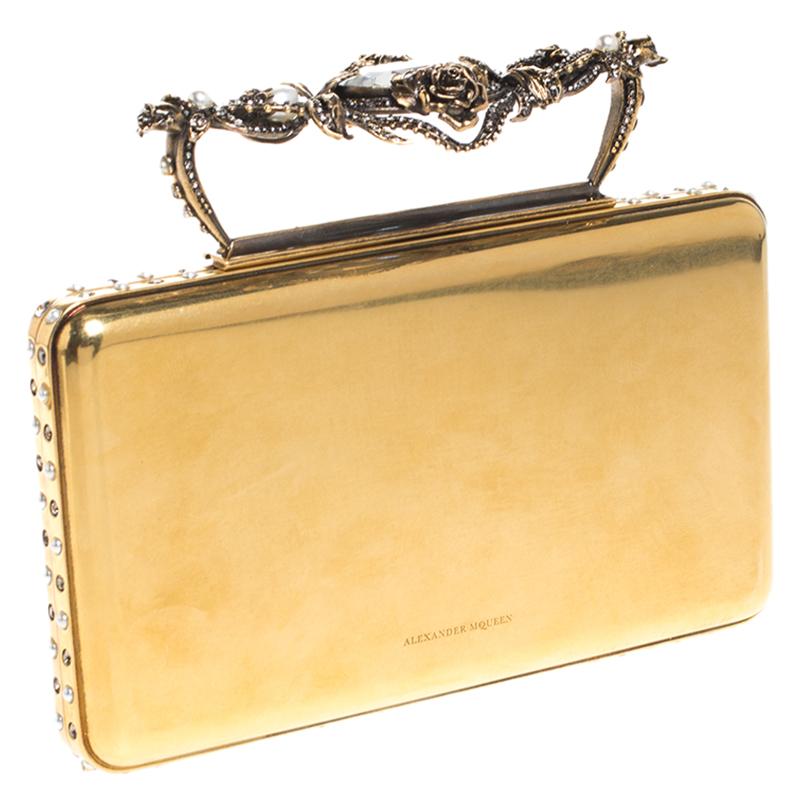 Creations so breathtaking and creative are hard to find! This awe-inspiring clutch from Alexander McQueen is just what you need to grab all the attention at those soirees and parties. We love the astoundingly designed top handle that makes this