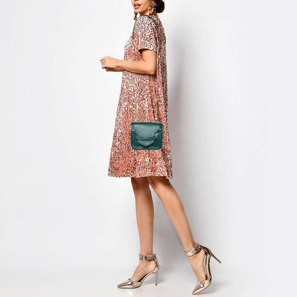 Every woman needs a bag that is gorgeous and functional, just like the Heroine bag from Alexander McQueen. Crafted from green leather, it has been styled in a lovely mini silhouette with a well-sized suede interior. A slender chain strap makes this