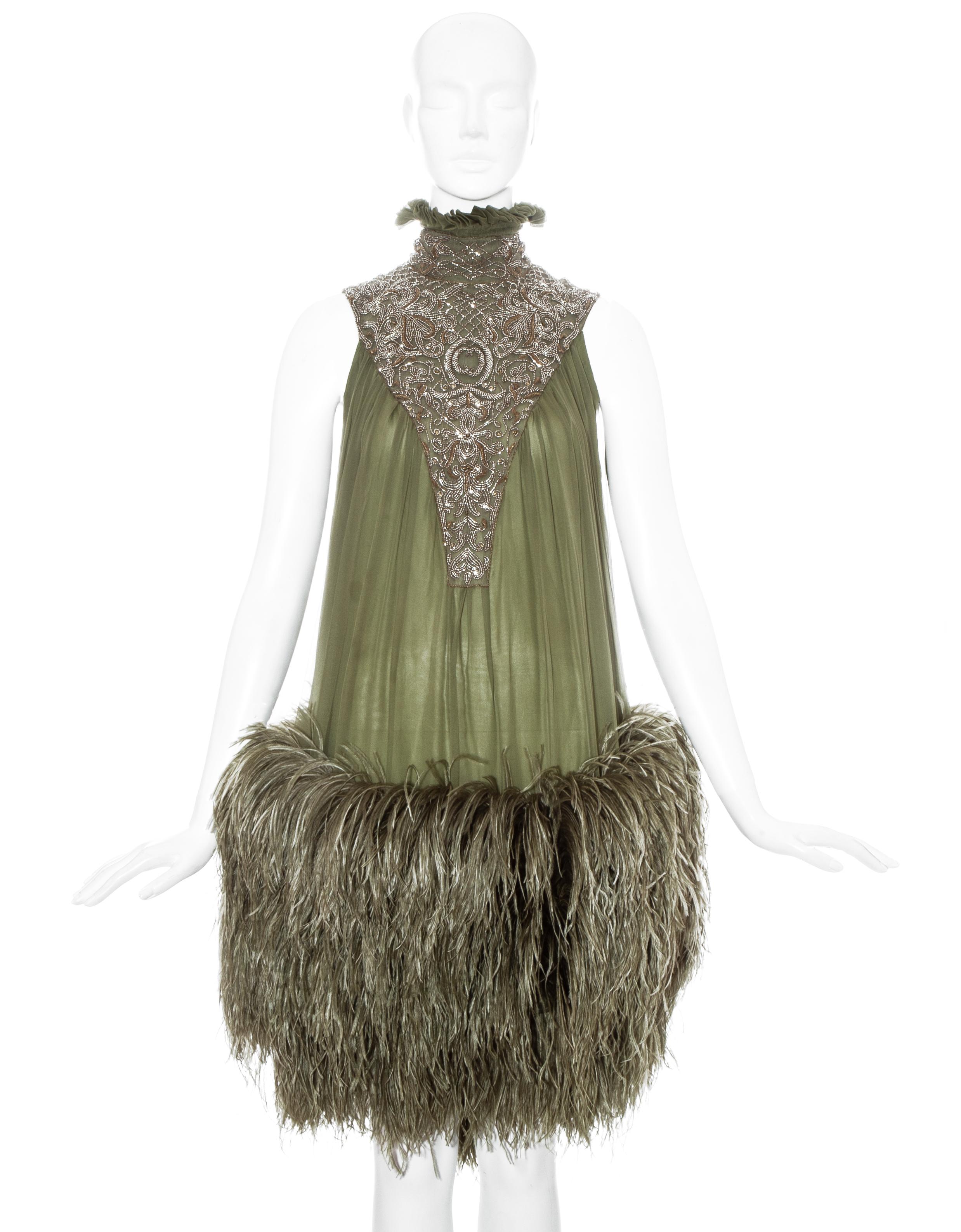 Alexander McQueen green silk chiffon evening dress with ostrich feather skirt, hand-sewn gold bead embellishment and high ruffled collar.

Fall-Winter 2006 