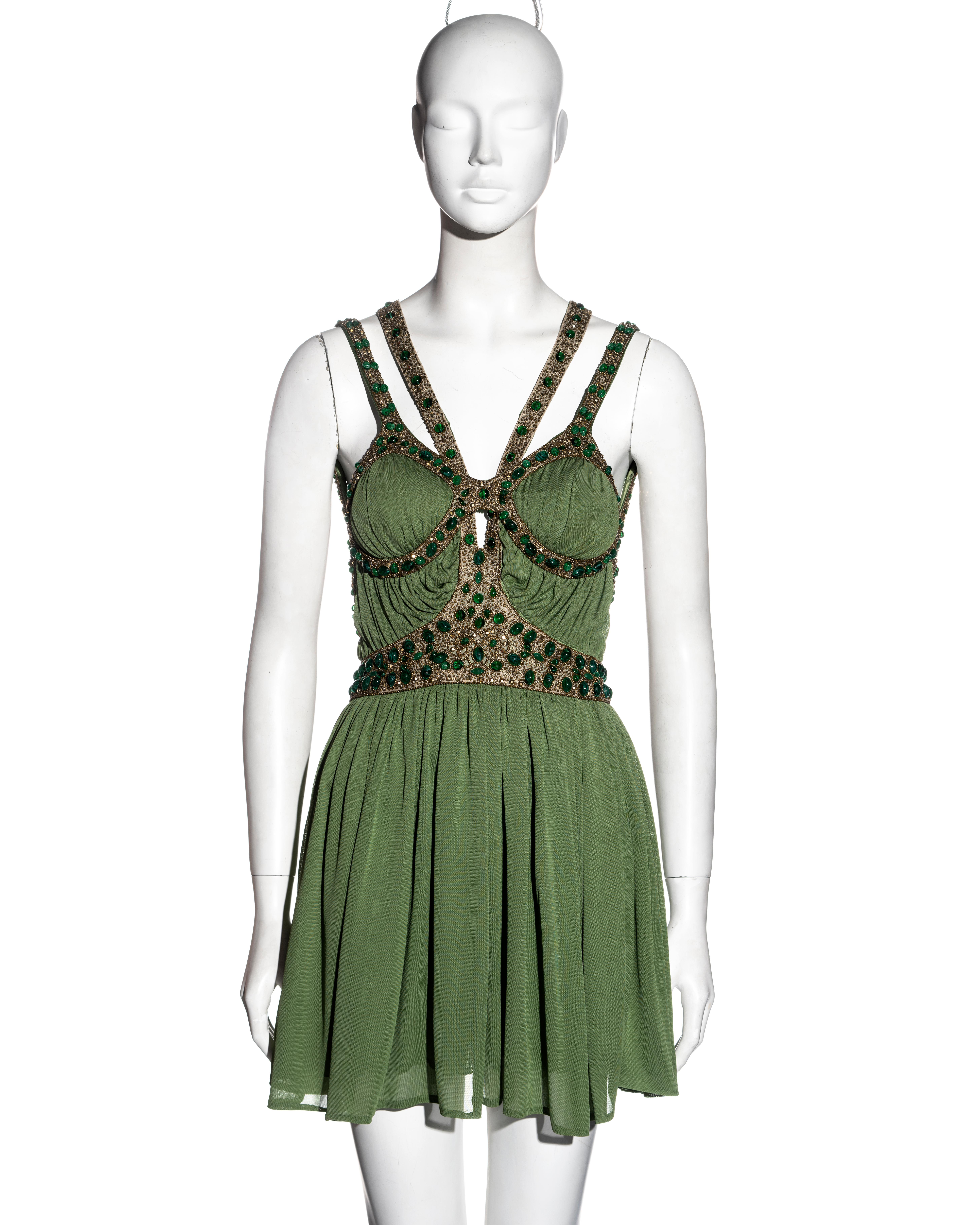 ▪ Alexander McQueen green silk jersey mini dress
▪ Straps, trim and waist covered in gold beads, Swarovski crystals and cabochon green stones
▪ Pleated mini skirt 
▪ Draped bodice 
▪ IT 40 - FR 36 - UK 8 - US 4
▪ Spring-Summer 2006
▪ Made in Italy