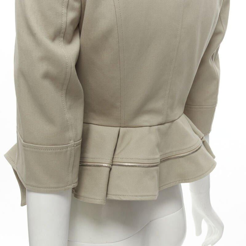 ALEXANDER MCQUEEN grey cotton fitted zipper trim peplum utility jacket IT38 XS
Reference: AAWC/A00114
Brand: Alexander McQueen
Material: Cotton
Color: Grey
Pattern: Solid
Closure: Button
Lining:  Cupro
Extra Details: Utility inspired flap pocket and
