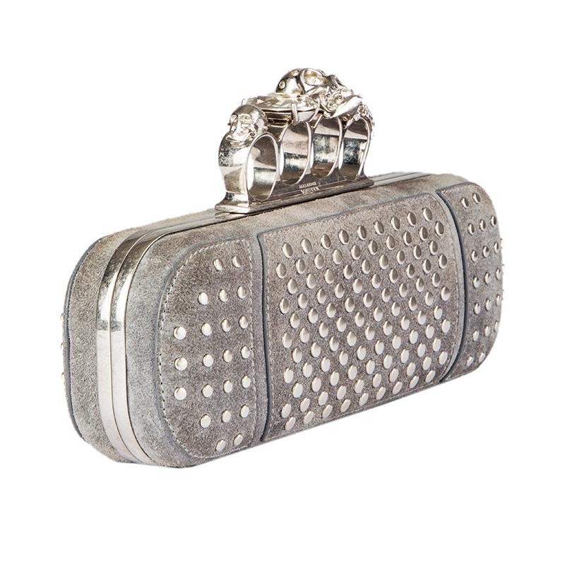 Alexander McQueen 'Studded Four-Ring' clutch in grey suede with antique silver flat studs. Frame-closure with bejewelled skull and giant rhinestone. Lined in black leather. Has been carried and is in excellent condition. Comes with dustbag.

Height