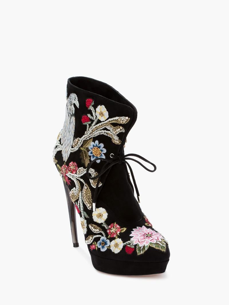 Alexander McQueen

Black super soft cashmere suede ankle boots with gorgeous embroidery and lace tie closure. Cuff can be styled up or folded down. Features the curved horn heel with hand-painted finish. External covered platform. Leather