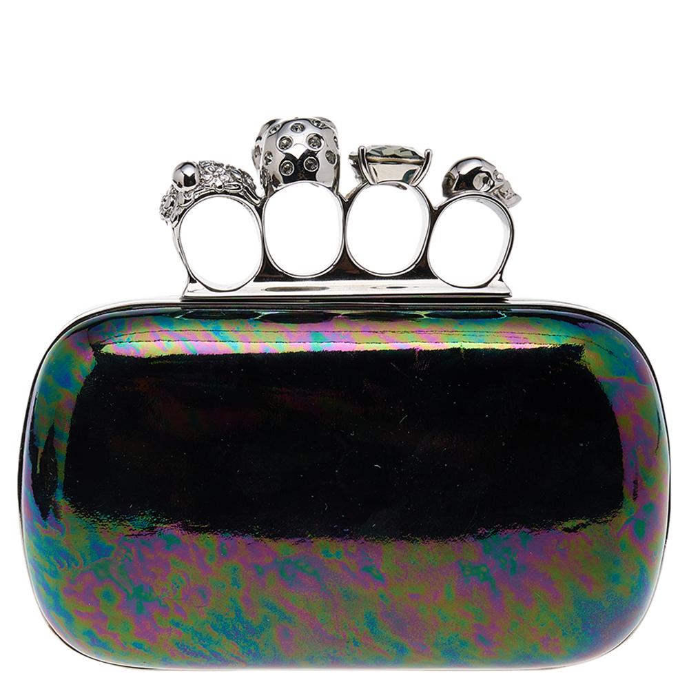 This Knuckle clutch from Alexander McQueen exudes a luxurious style. Crafted from holographic leather and silver-tone metal, it has a sleek finish and comes with a well-sized interior. This piece is complete with a knuckle slot on top. Flaunt this