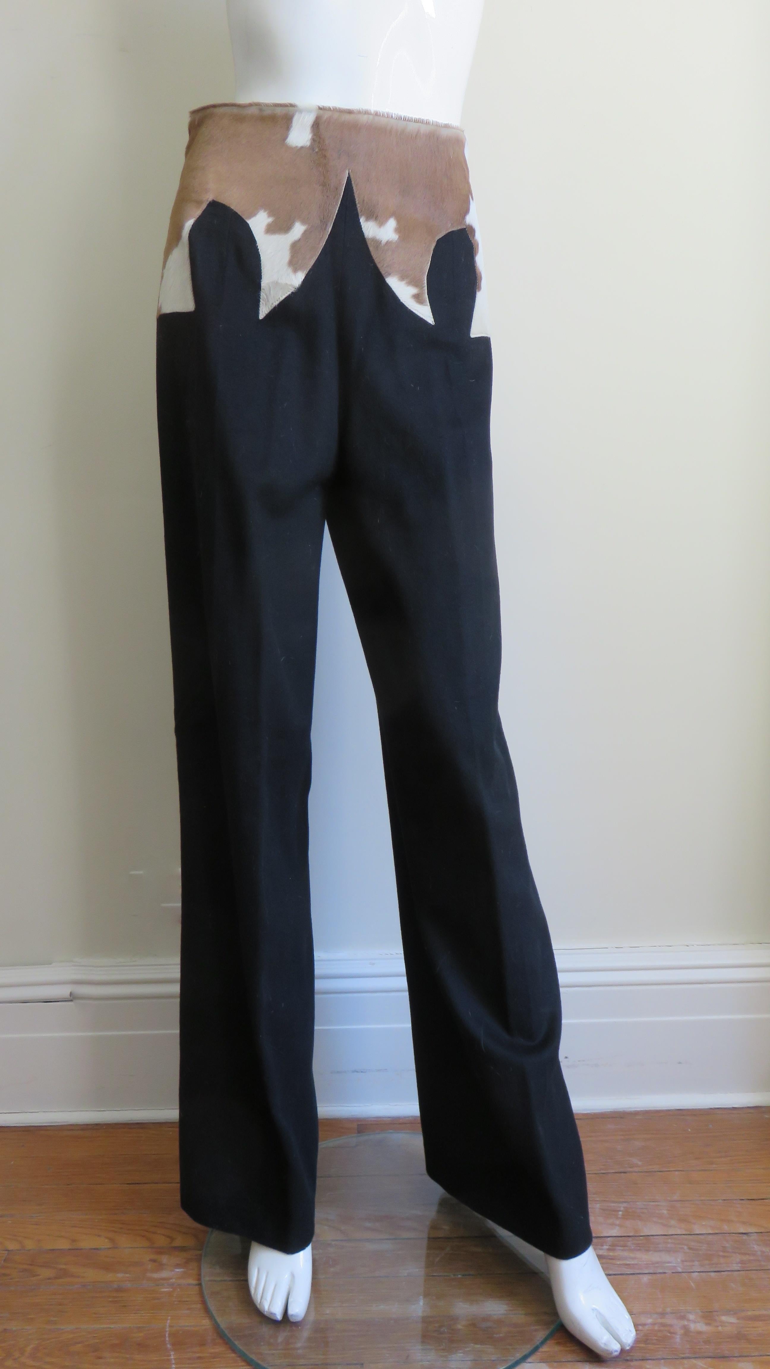 Fabulous black wool pants by Alexander McQueen from his famous iconic 'It's a Jungle Out There' F/W 1997 collection. They are a real stand out with a stylized multi point cowhide yoke applique at the waist. They have straight legs and a and side