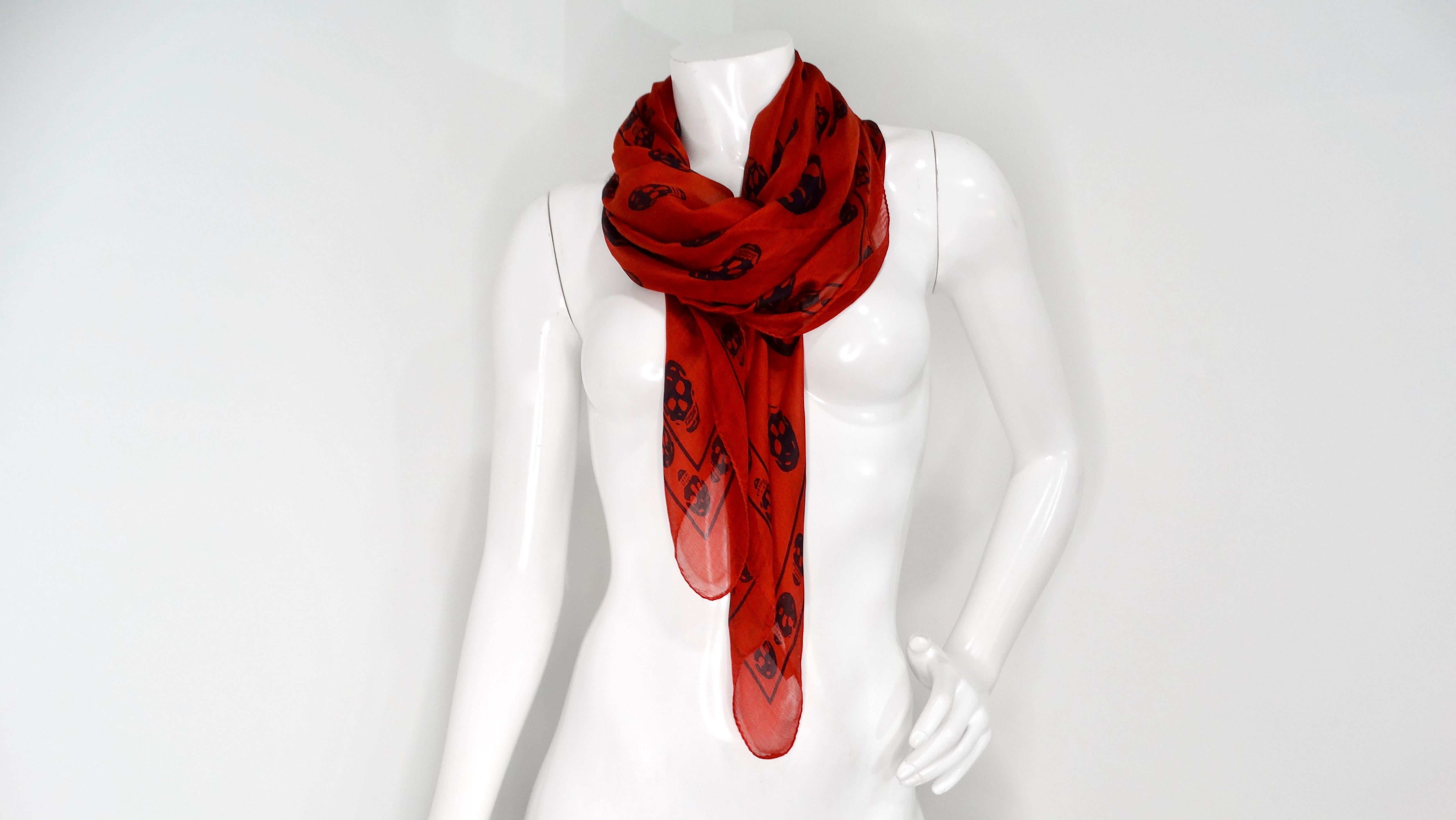 The Alexander McQueen Iconic Red Skull Print Silk Scarf is a striking piece that embodies the daring and avant-garde spirit of the renowned designer. Known for his theatrical and rebellious approach, McQueen’s signature skull motif melds seamlessly