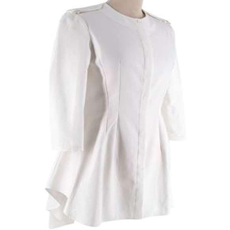 Alexander McQueen Ivory Waffle-Cotton Collarless Tunic

- Ivory tunic in waffle-textured cotton pique
- Collarless
- Decorative tonal epaulettes
- Bracelet length sleeves, with button finished cuff
- Concealed button-up fastening
- Flared asymmetric