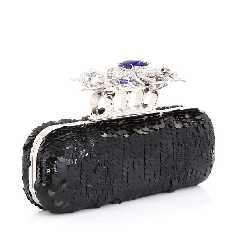 This Alexander McQueen Knuckle Box Clutch Sequin Embellished Leather Long, crafted in black sequin-embellished leather, features knuckle handle embellished with a large crystals and silver-tone hardware. It opens to a matching black leather