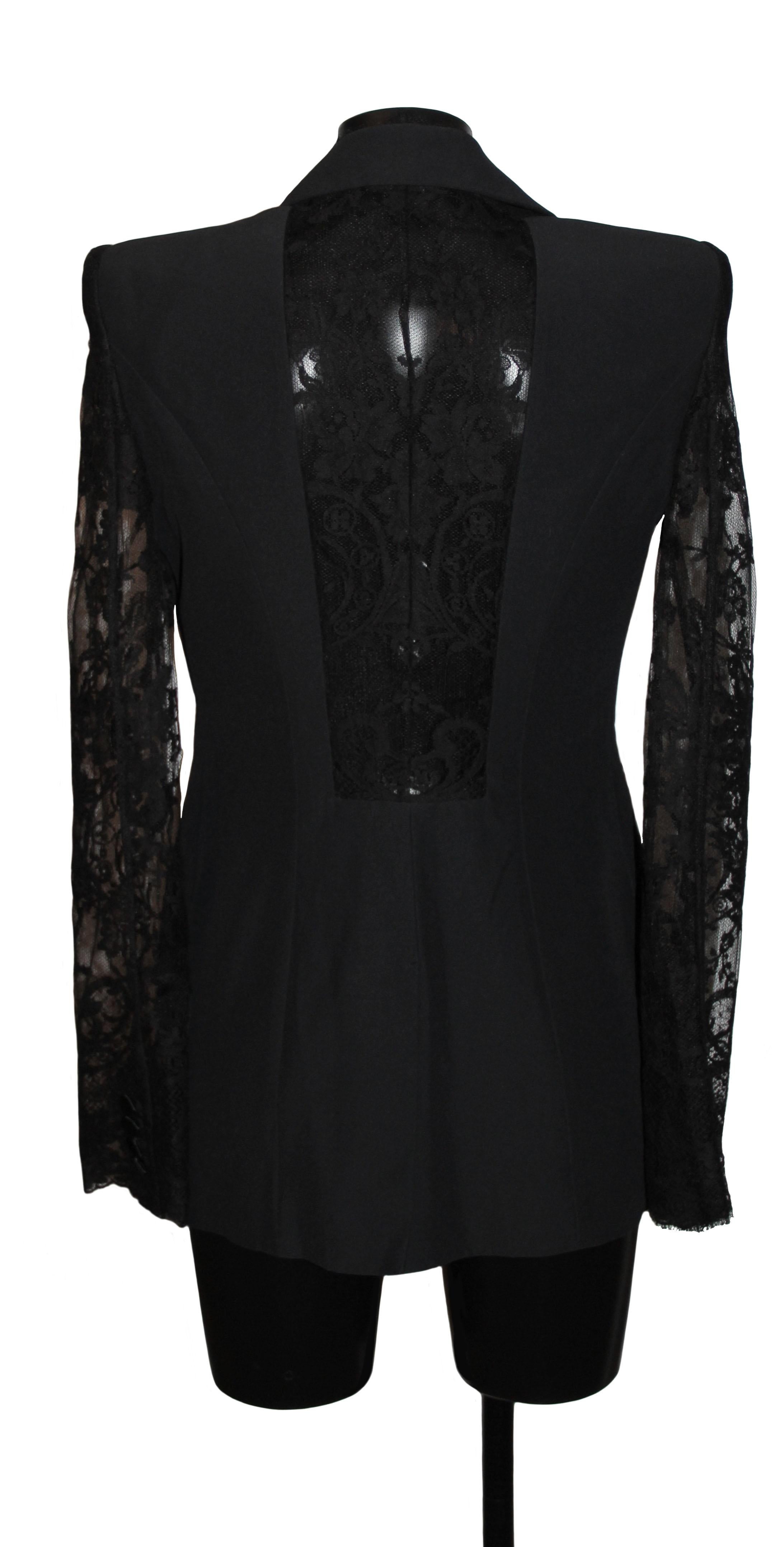 This pre-owned in pristine condition black crepe tuxedo jacket represents the talent of Alexander McQueen.
The mix of delicate lace and plain fabric is designed to accentuate the feminity of a tuxedo jacket.

It features lace sleeves and lace back