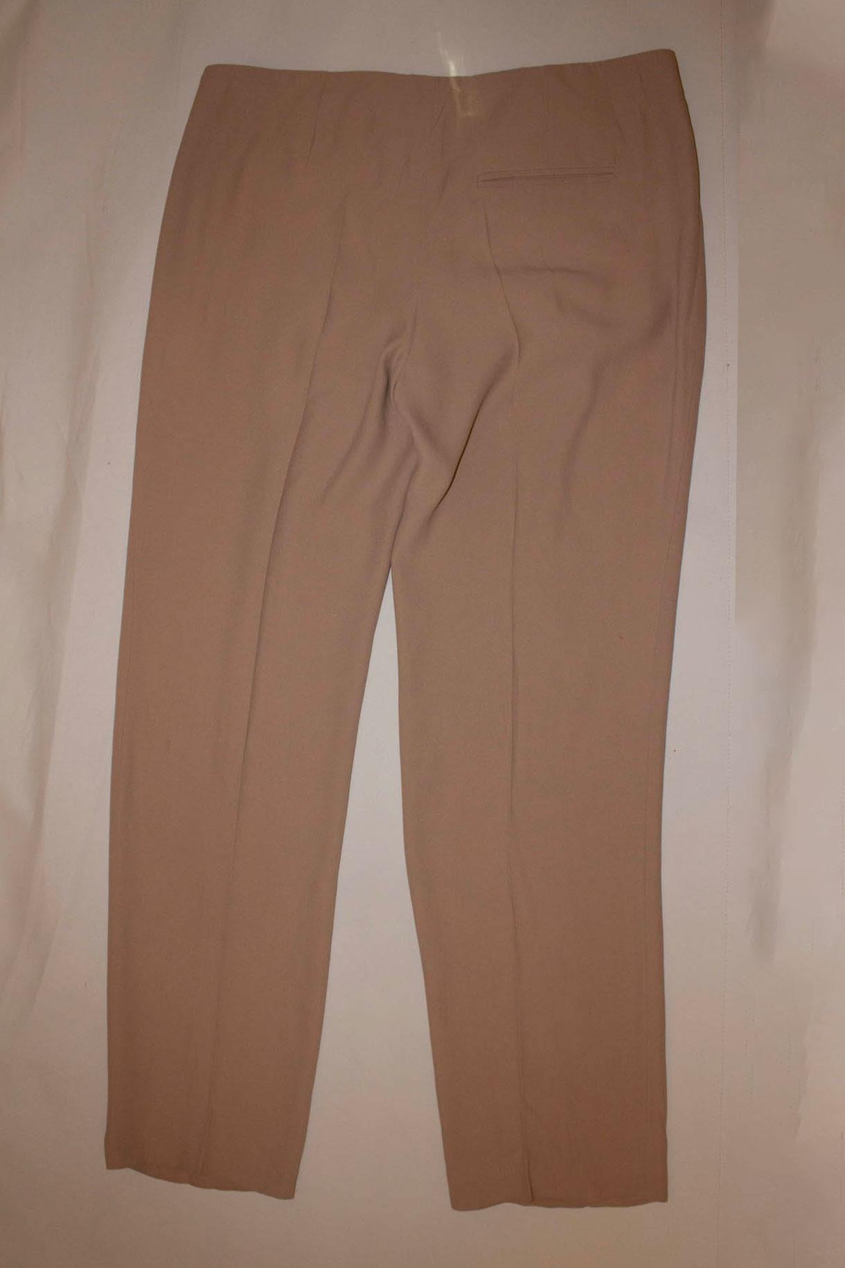 A chic pair of pants /trousers by Alexander Mc Queen mainline.  In a beautiful shade of beige the trousers have a side zip opening, and three button detail on the front. Size 44 
Measurements: Waist 33'' , inside leg 31'', hem 1 3/4''