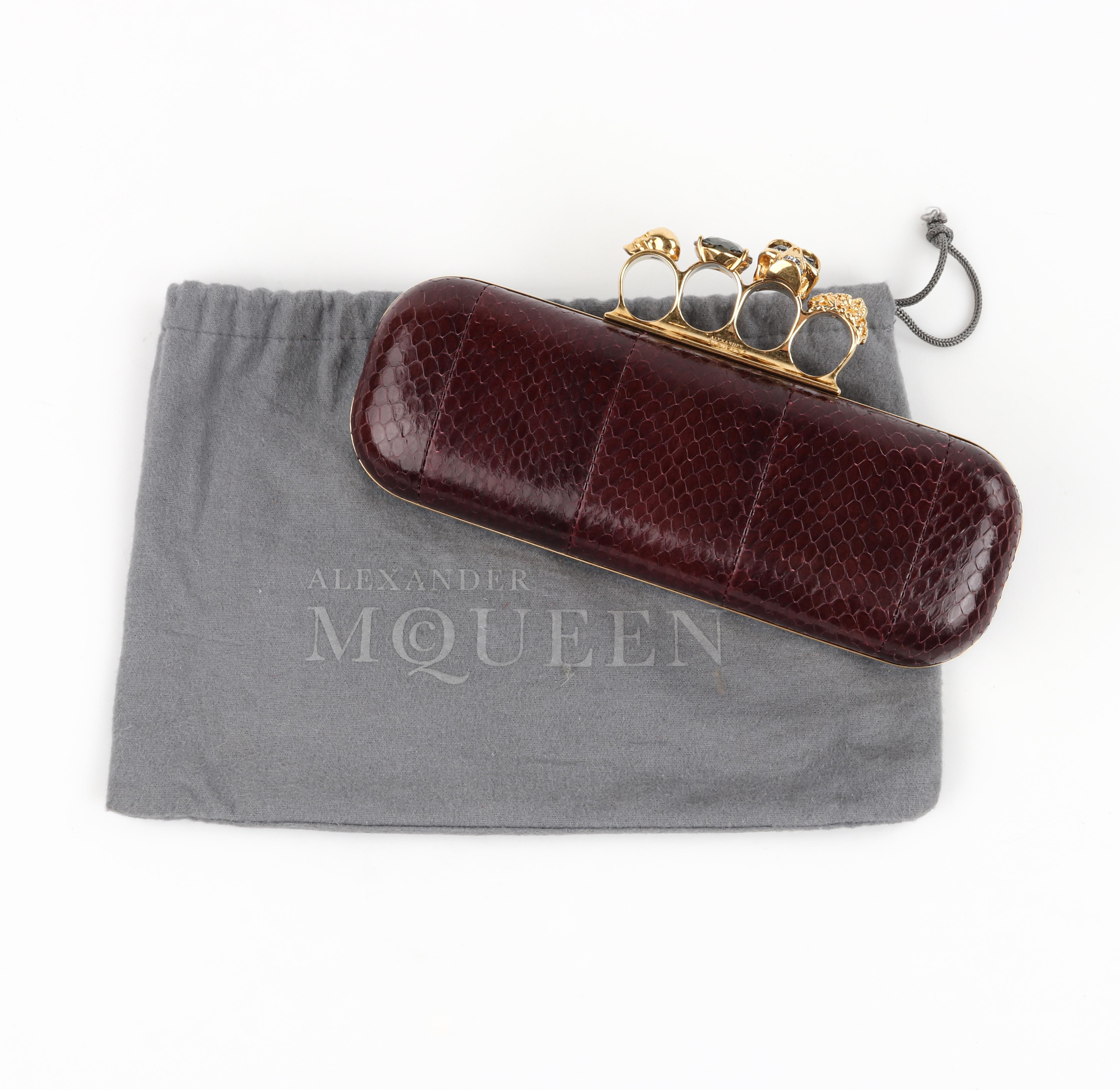 ALEXANDER McQUEEN Maroon Python Snakeskin Skull Knuckle Ring Duster Box Clutch 

Brand / Manufacturer: Alexander McQueen
Style: Clutch
Color(s): Maroon exterior, Gold hardware, Gray Crystal Stones, Black interior
Unmarked Fabric (feel of): Python