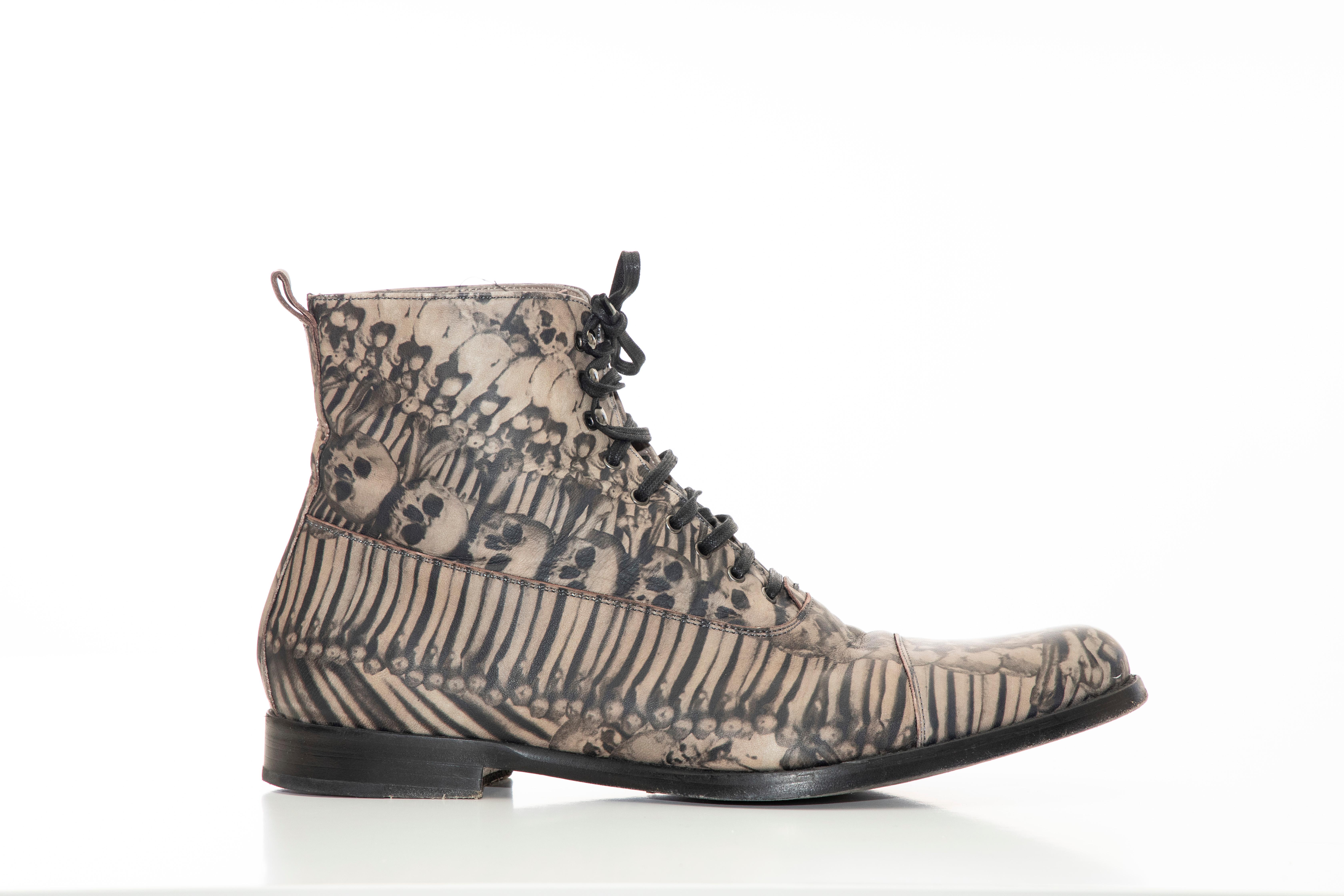 Alexander McQueen, Fall 2010 men's skull & bones printed leather ankle boots featuring , lace-tie closures at uppers, pull tabs at counters and stacked heels. 

Includes box.

Heels: 1
