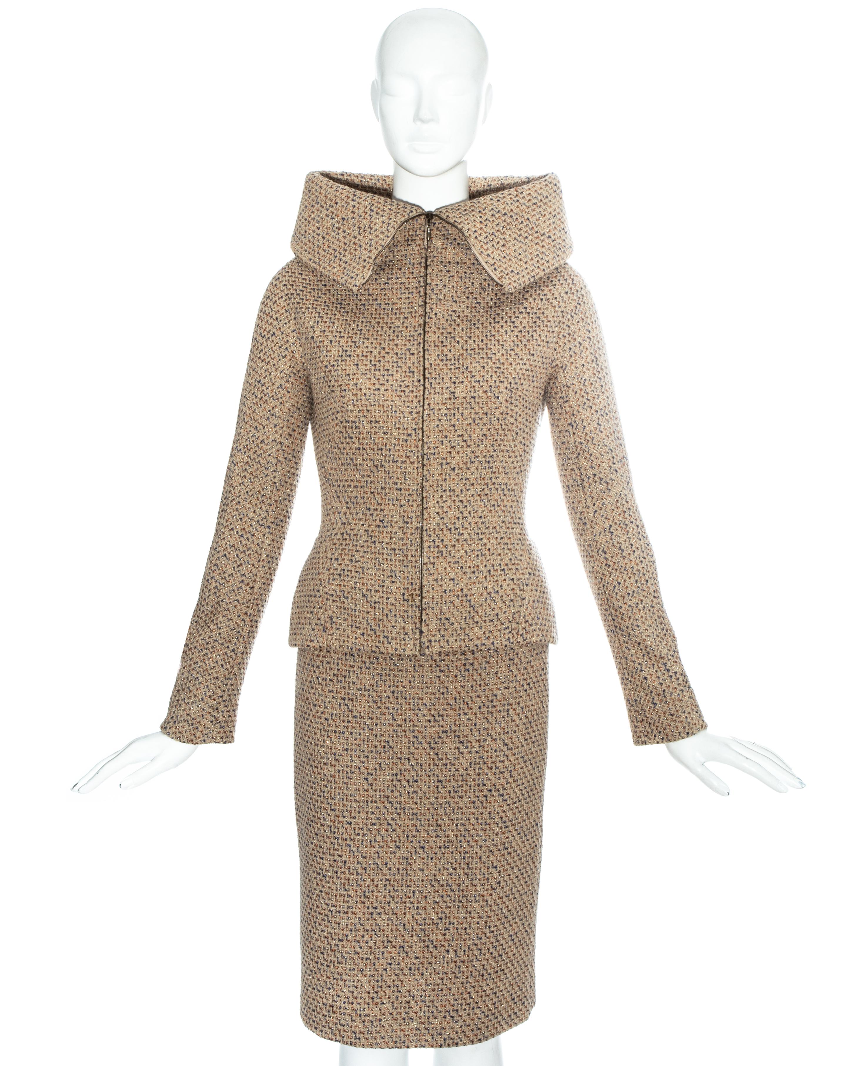 Alexander McQueen metallic tweed skirt suit. Structured jacket with high turn-over collar, front zip fastening, silk lining and Chanel style chain on the hem. Sold with matching knee length pencil skirt. 

Fall-Winter 2004
