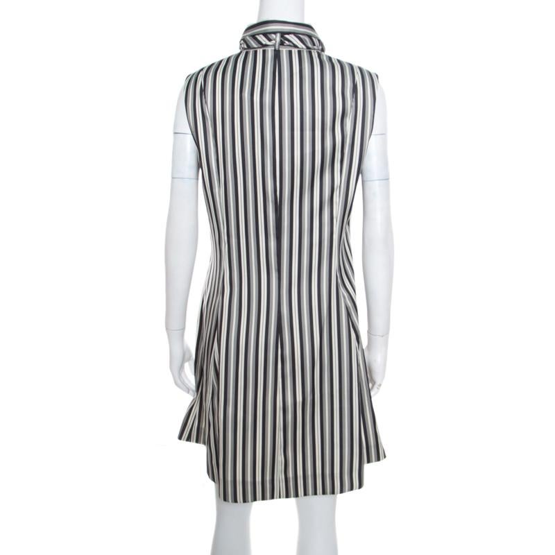 Graced with a gorgeous silhouette, this McQ by Alexander McQueen dress is second to none in terms of style, class, and comfort. A sophisticated piece, the outfit is adorned with a monochrome striped pattern all over and has a detachable necktie. A