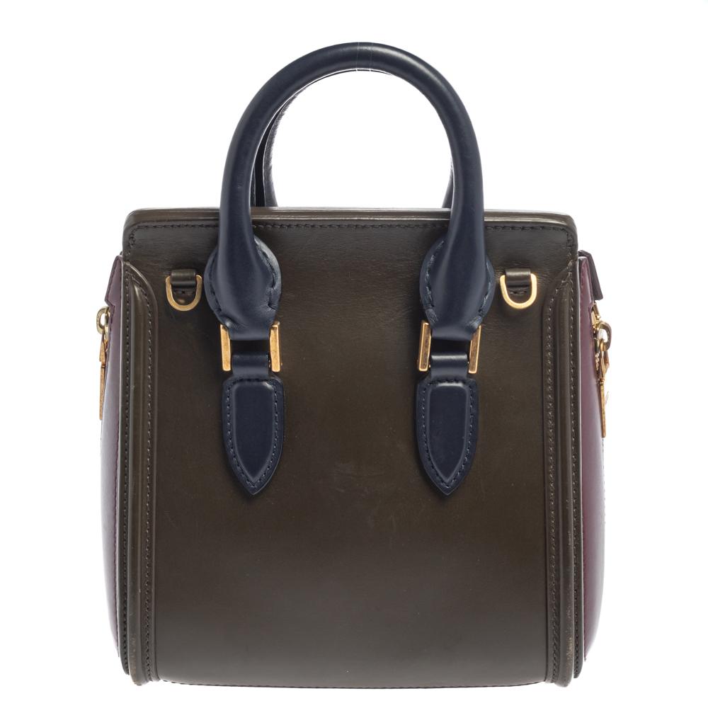 Every woman needs a bag that is pretty and functional, just like this shoulder bag from Alexander McQueen. Crafted from leather, it has been styled with a flap leading to a spacious suede interior and it is held by two top handles. This is