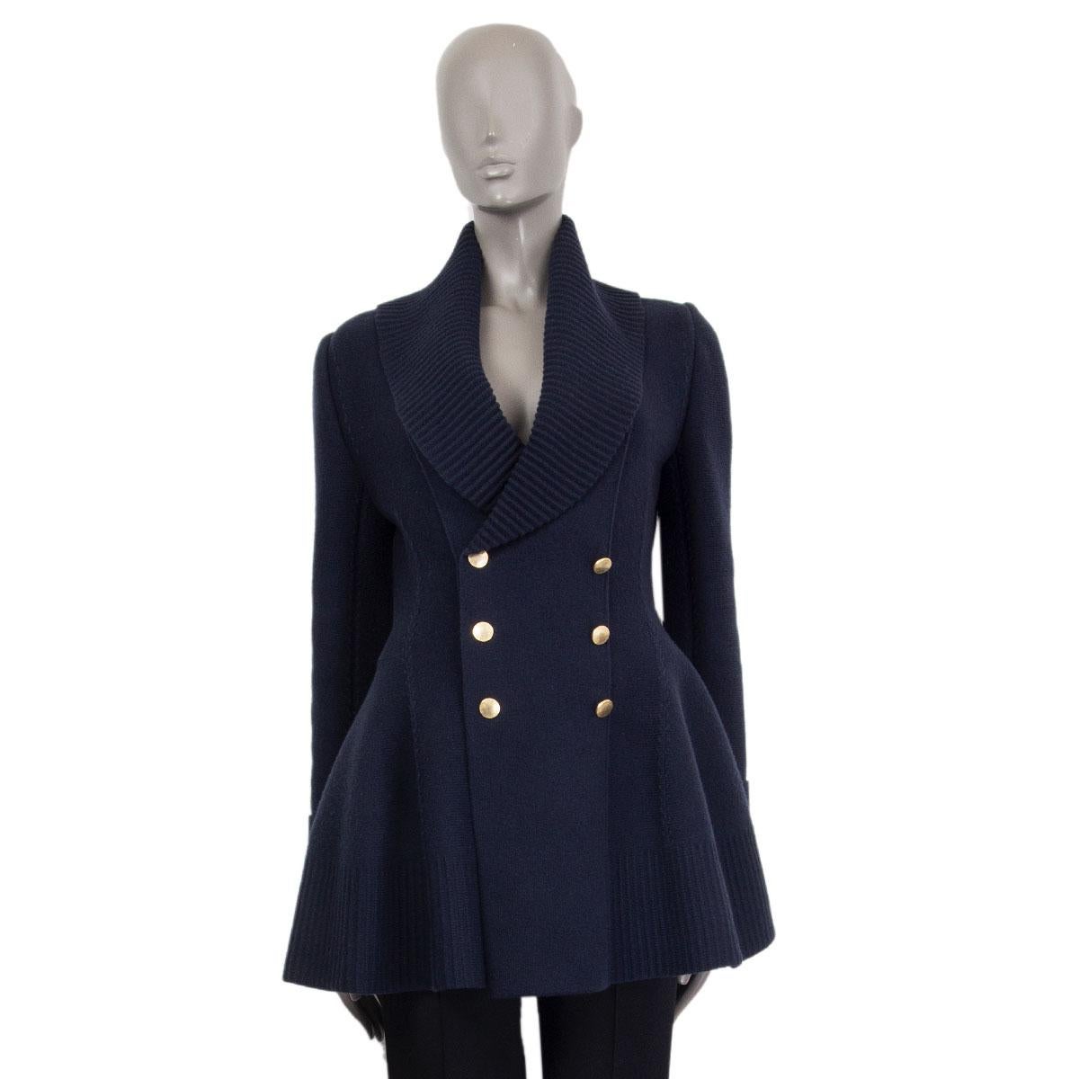 Alexander McQueen double breasted jacket in navy blue wool (79%), cashmere (19%), polyamide (1%) and elastane (1%) with a wide collar. Closes on the front with gold tone buttons. Unlined. Has been worn and is in excellent condition. 

Tag Size M