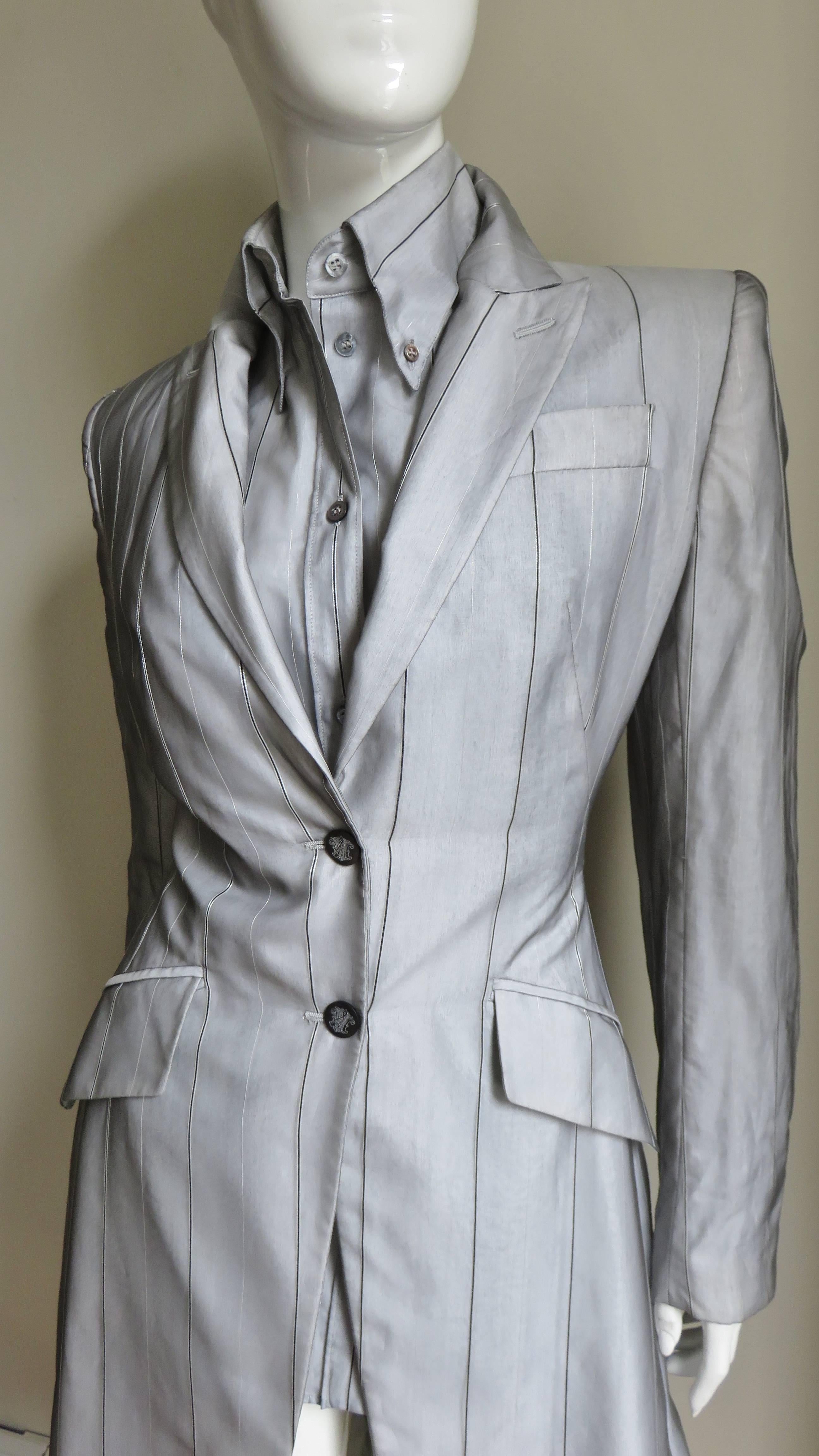 A fabulous 2 piece set by Alexander McQueen consisting of a long jacket and shirt in grey sheer silk with fine black and silver stripes over white. The shirt has a grey mother of pearl button down collar, button front, and sleeve cuffs plus a back